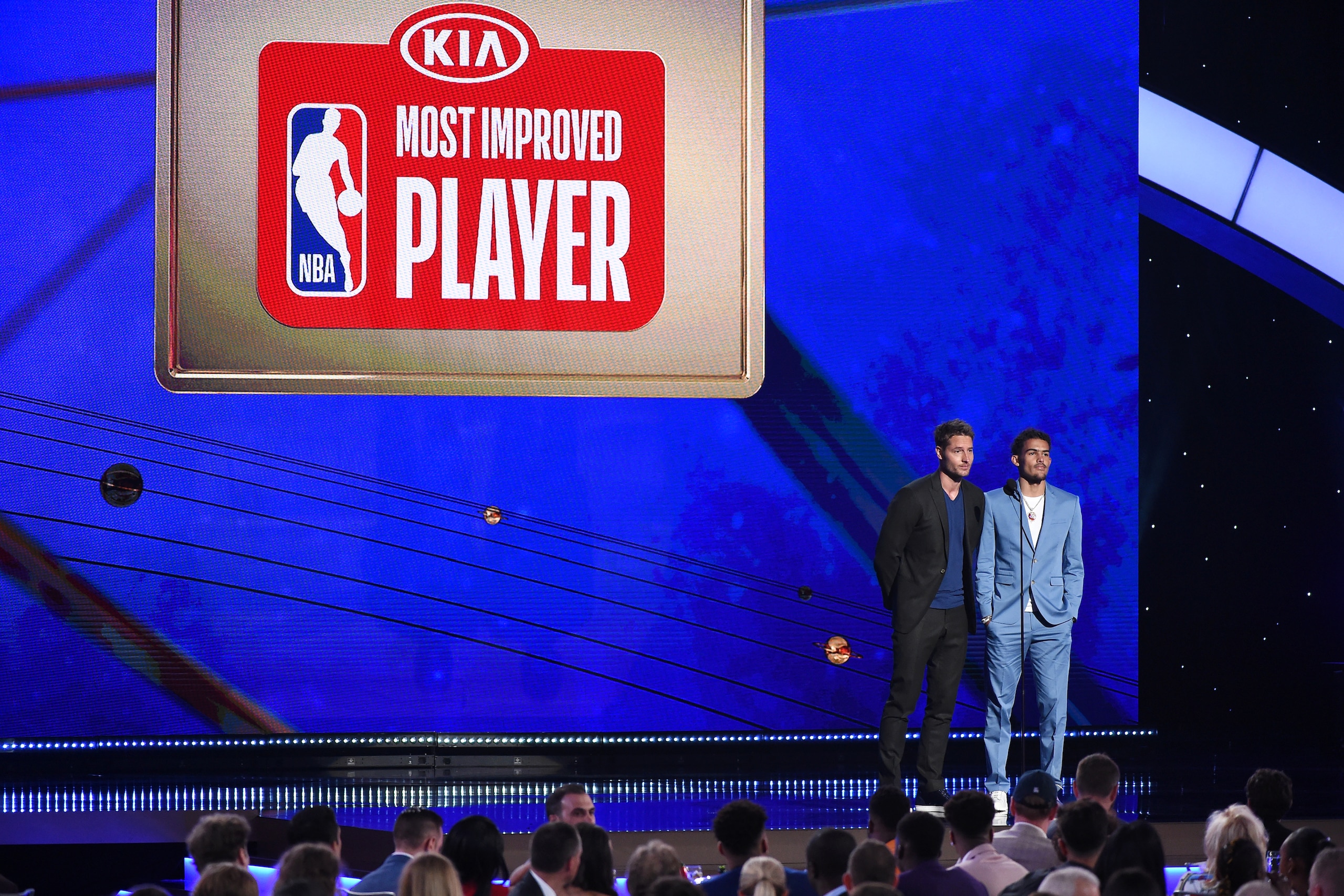 SANTA MONICA, CA - JUNE 24:  Actor Justin Hartley and Trae Young #11 of the Atlanta Hawks present the KIA Most Improved Player Award during the 2019 NBA Awards Show on June 24, 2019 at Barker Hangar in Santa Monica, California. NOTE TO USER: User expressly acknowledges and agrees that, by downloading and/or using this photograph, user is consenting to the terms and conditions of the Getty Images License Agreement. Mandatory Copyright Notice: Copyright 2019 NBAE  (Photo by Adam Pantozzi/NBAE via Getty Images)