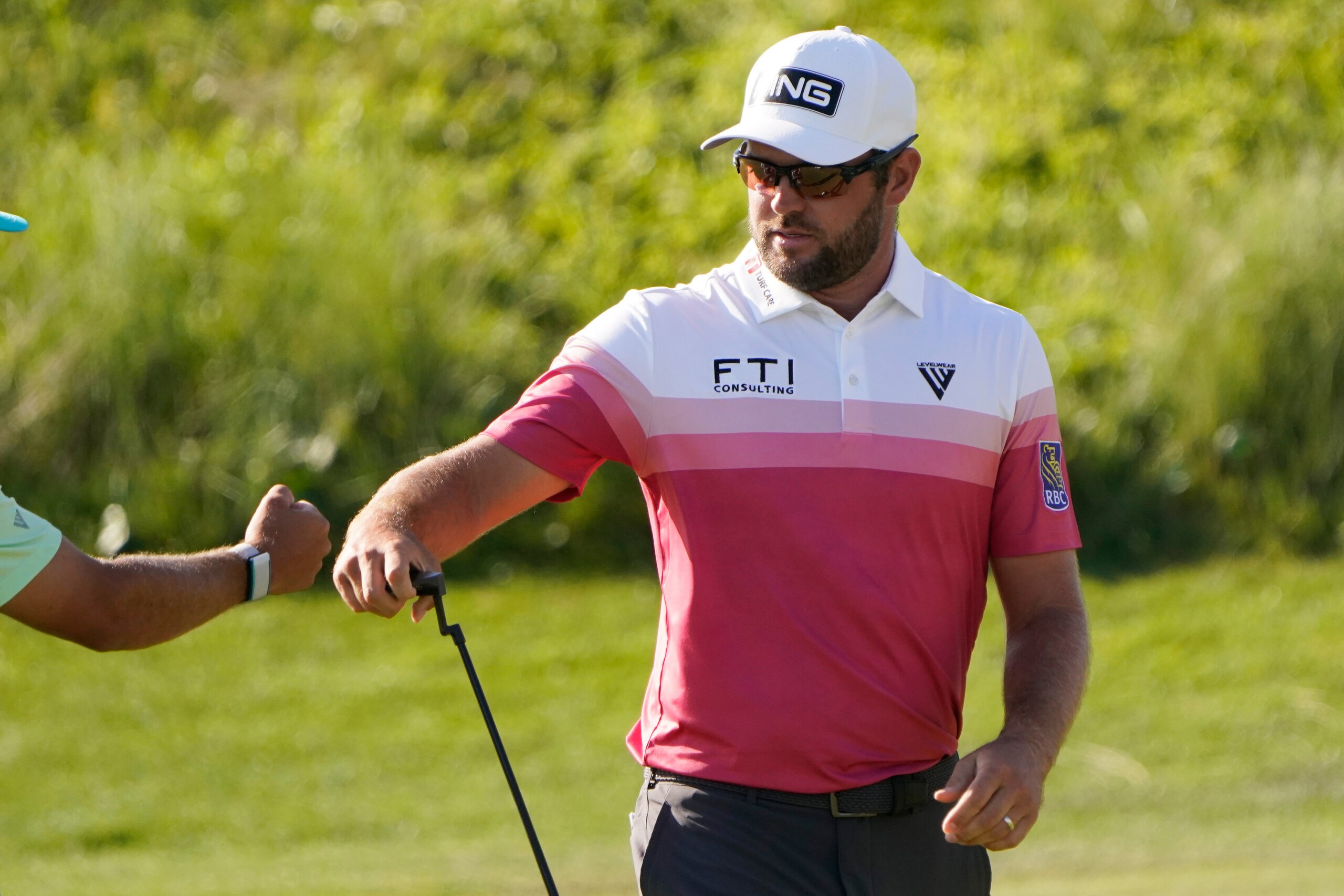 Corey Conners, of Canada, fist bumps his caddie after a putt on the 17th hole during the first round of the PGA Championship golf tournament on the Ocean Course Thursday, May 20, 2021, in Kiawah Island, S.C. (AP Photo/Chris Carlson)
