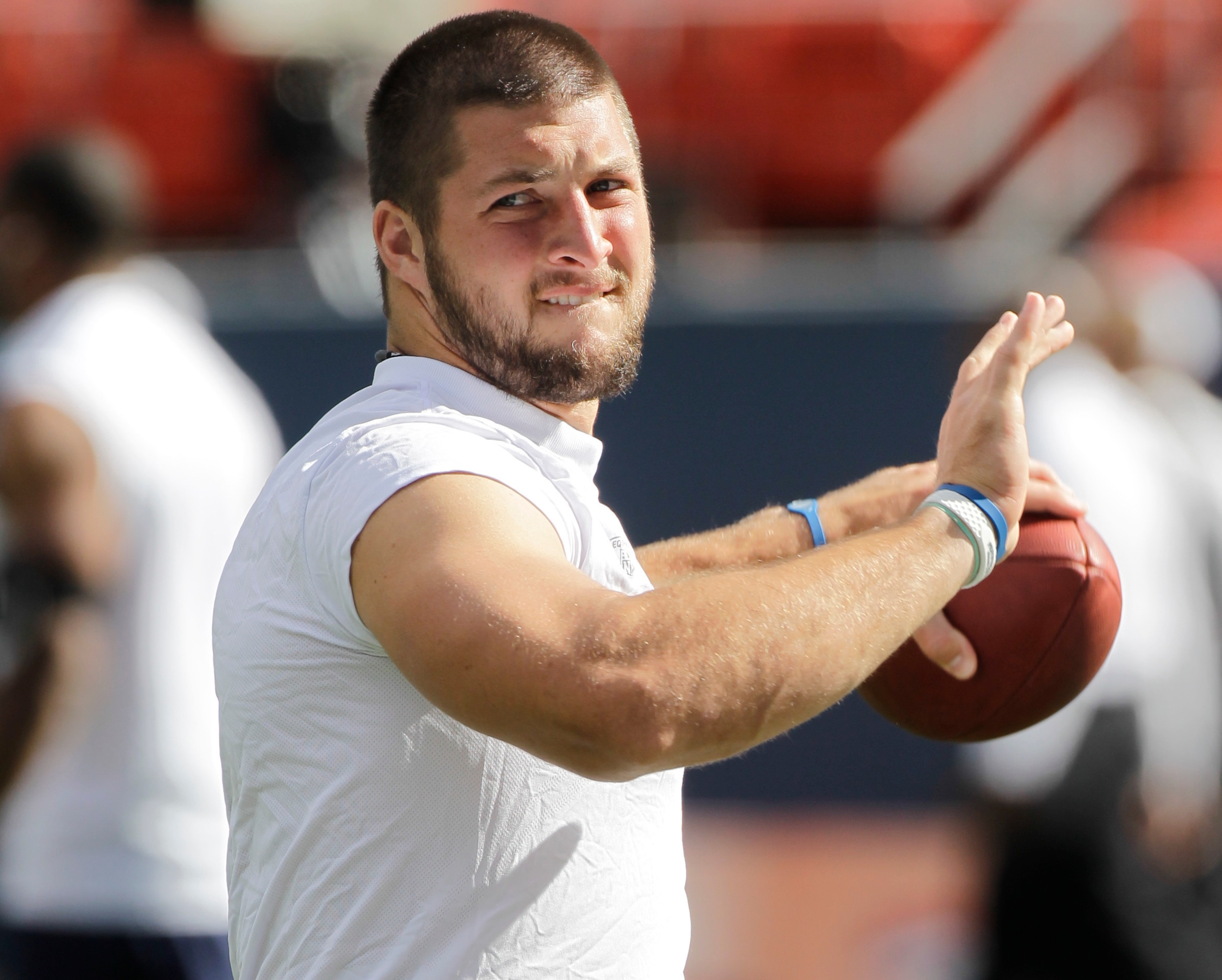 FILE - In this Sunday, Aug. 29, 2010 file photo, Denver Broncos quarterback Tim Tebow warms up before a preseason NFL football game against the Pittsburgh Steelers in Denver. Joe Horrigan calls it a “many decades love affair with football.” Readers of his book, “NFL Century,” will call it masterful. New Broncos coach Vic Fangio snipped the annual summer ritual of Denver Broncos veterans giving rookies hideous haircuts. (AP Photo/Jack Dempsey, File)