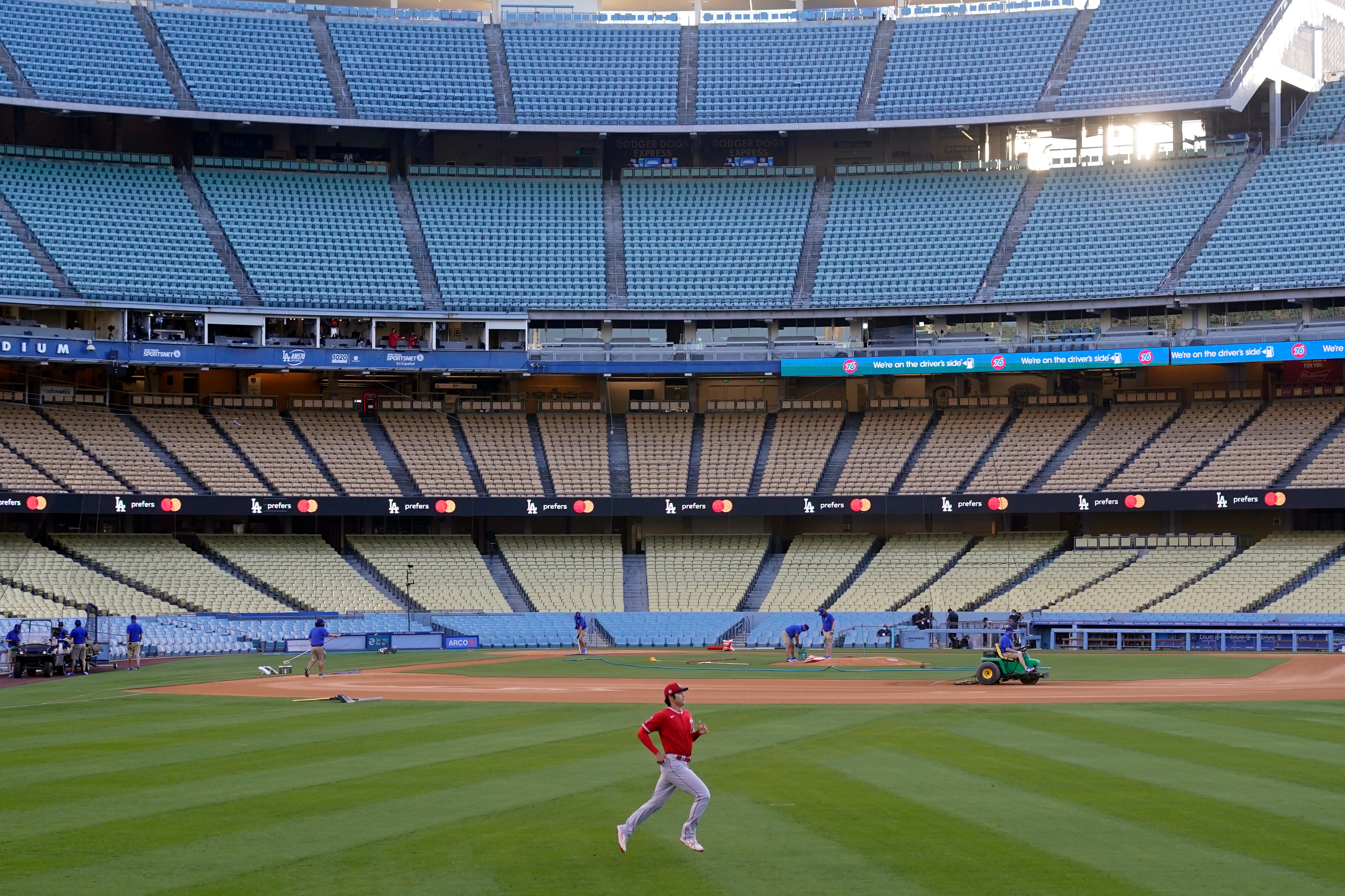 Los Angeles Angels starting pitcher Shohei Ohtani warms in an empty Dodger Stadium before a spring training exhibition baseball game against the Los Angeles Dodgers, Monday, March 29, 2021, in Los Angeles. (AP Photo/Marcio Jose Sanchez)