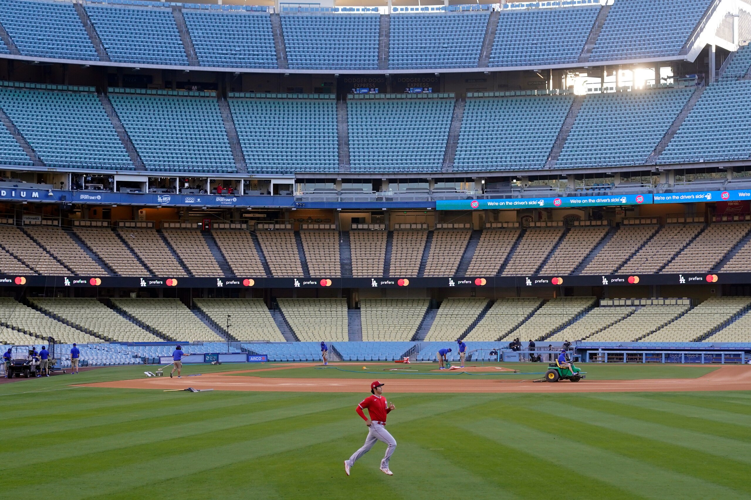 Los Angeles Angels starting pitcher Shohei Ohtani warms in an empty Dodger Stadium before a spring training exhibition baseball game against the Los Angeles Dodgers, Monday, March 29, 2021, in Los Angeles. (AP Photo/Marcio Jose Sanchez)