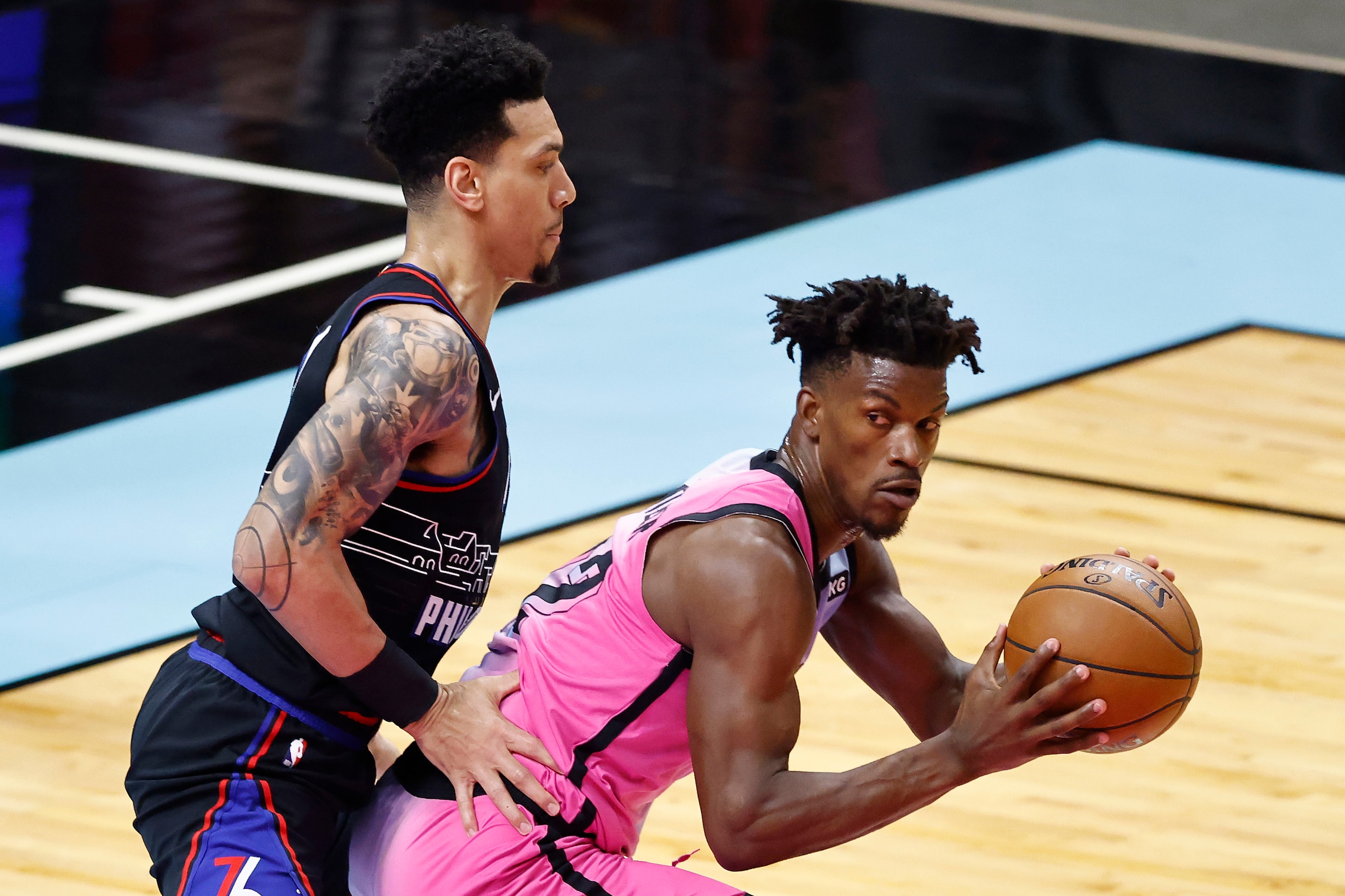 MIAMI, FLORIDA - MAY 13: Jimmy Butler #22 of the Miami Heat is defended by Danny Green #14 of the Philadelphia 76ers during the first quarter at American Airlines Arena on May 13, 2021 in Miami, Florida. NOTE TO USER: User expressly acknowledges and agrees that, by downloading and or using this photograph, User is consenting to the terms and conditions of the Getty Images License Agreement. (Photo by Michael Reaves/Getty Images)
