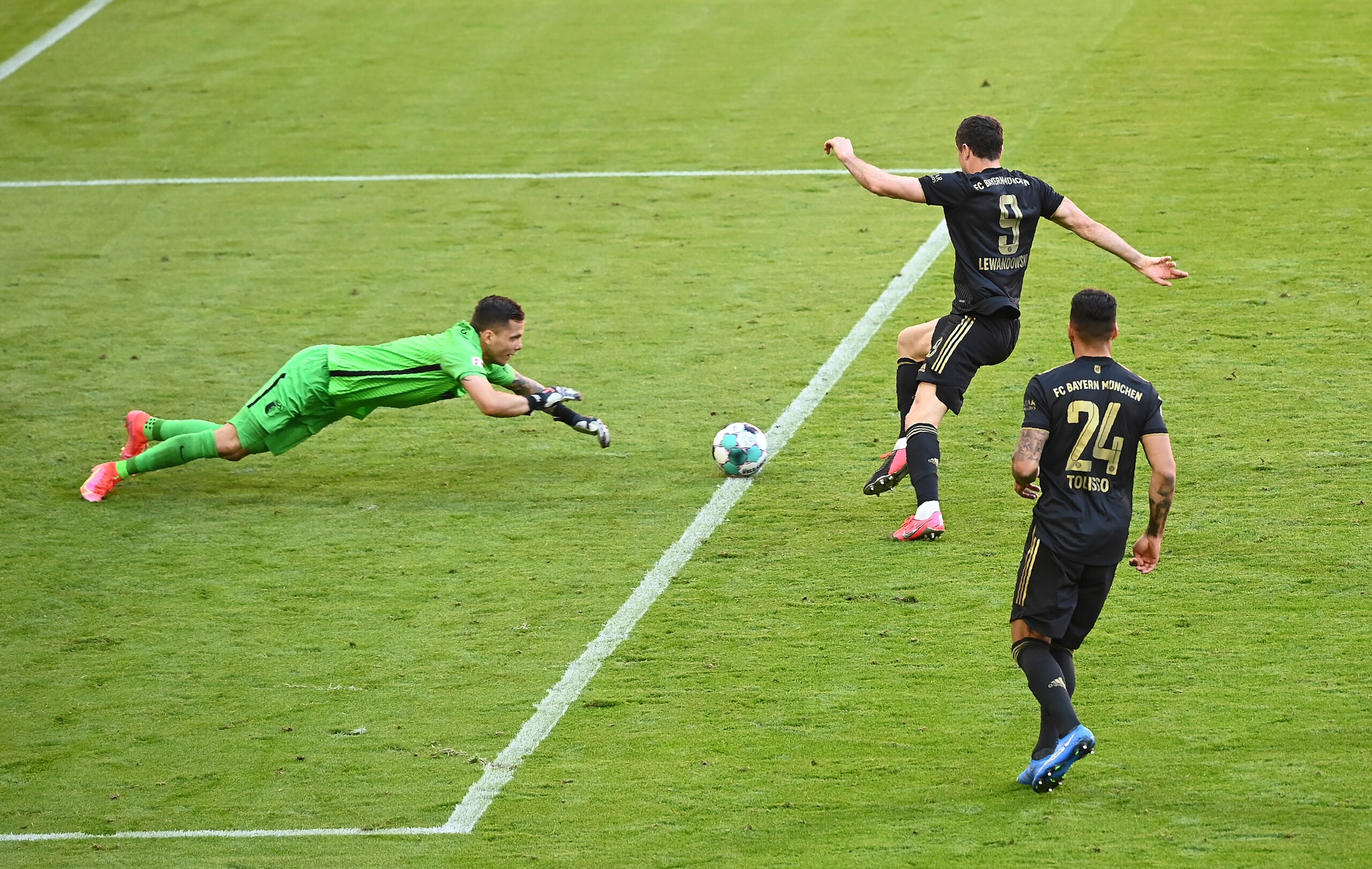 Bayern's Robert Lewandowski, top right, scores his side's fifth goal during the Bundesliga soccer match between Bayern Munich and FC Augsburg at the Allianz Arena stadium in Munich, Germany, Saturday, May 22, 2021. (Sven Hoppe, Pool via AP)