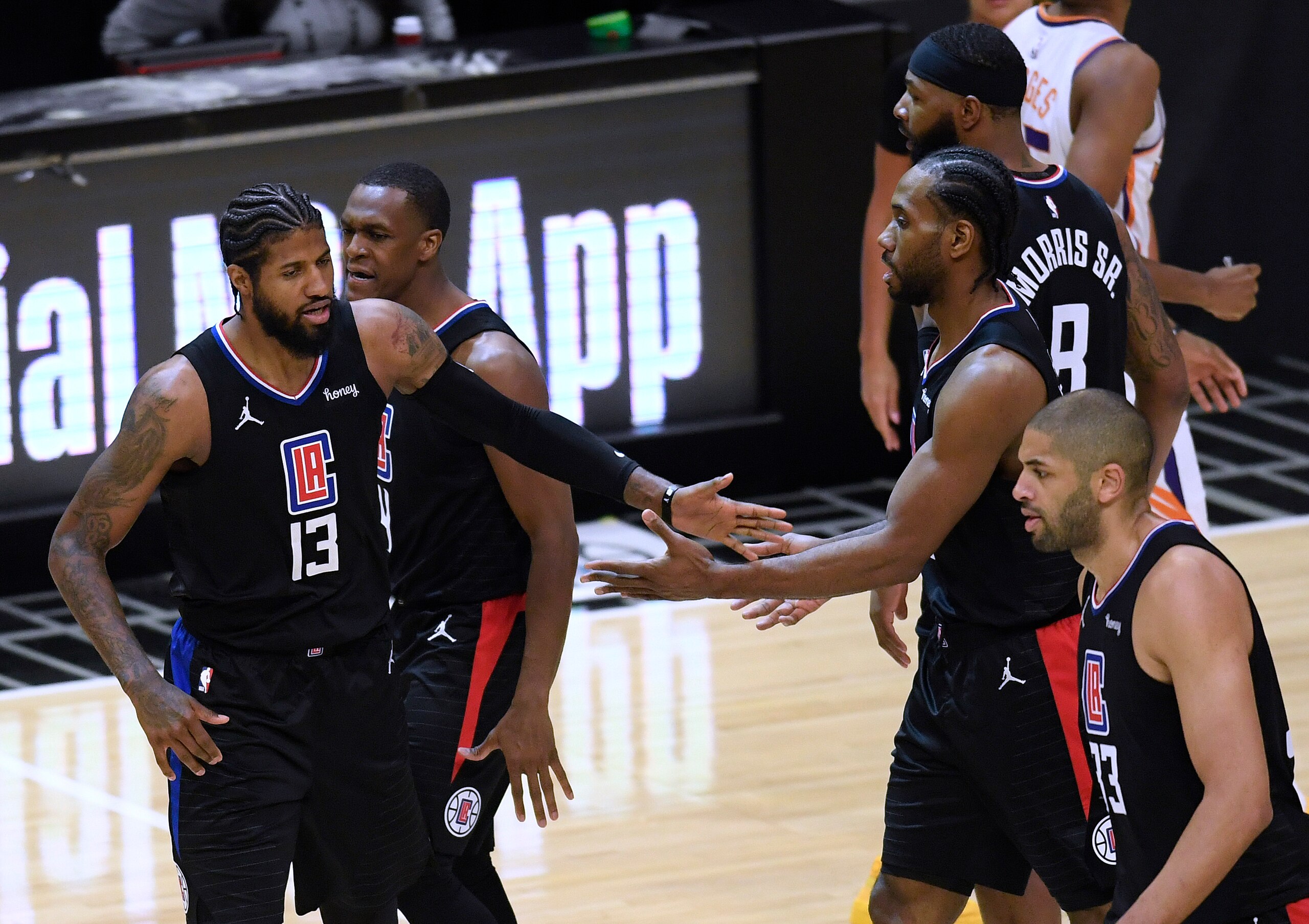 LOS ANGELES, CALIFORNIA - APRIL 08: Paul George #13 of the LA Clippers celebrates a lead with Kawhi Leonard #2 after a tinmeout during the fourth quarter in a 113-103 Clippers win over the Phoenix Suns at Staples Center on April 08, 2021 in Los Angeles, California. (Photo by Harry How/Getty Images) NOTE TO USER: User expressly acknowledges and agrees that, by downloading and or using this photograph, User is consenting to the terms and conditions of the Getty Images License Agreement. LOS ANGELES, CALIFORNIA - APRIL 08: Paul George #13 of the LA Clippers celebrates a lead with Kawhi Leonard #2 after a tinmeout during the fourth quarter in a 113-103 Clippers win over the Phoenix Suns at Staples Center on April 08, 2021 in Los Angeles, California. (Photo by Harry How/Getty Images) NOTE TO USER: User expressly acknowledges and agrees that, by downloading and or using this photograph, User is consenting to the terms and conditions of the Getty Images License Agreement.