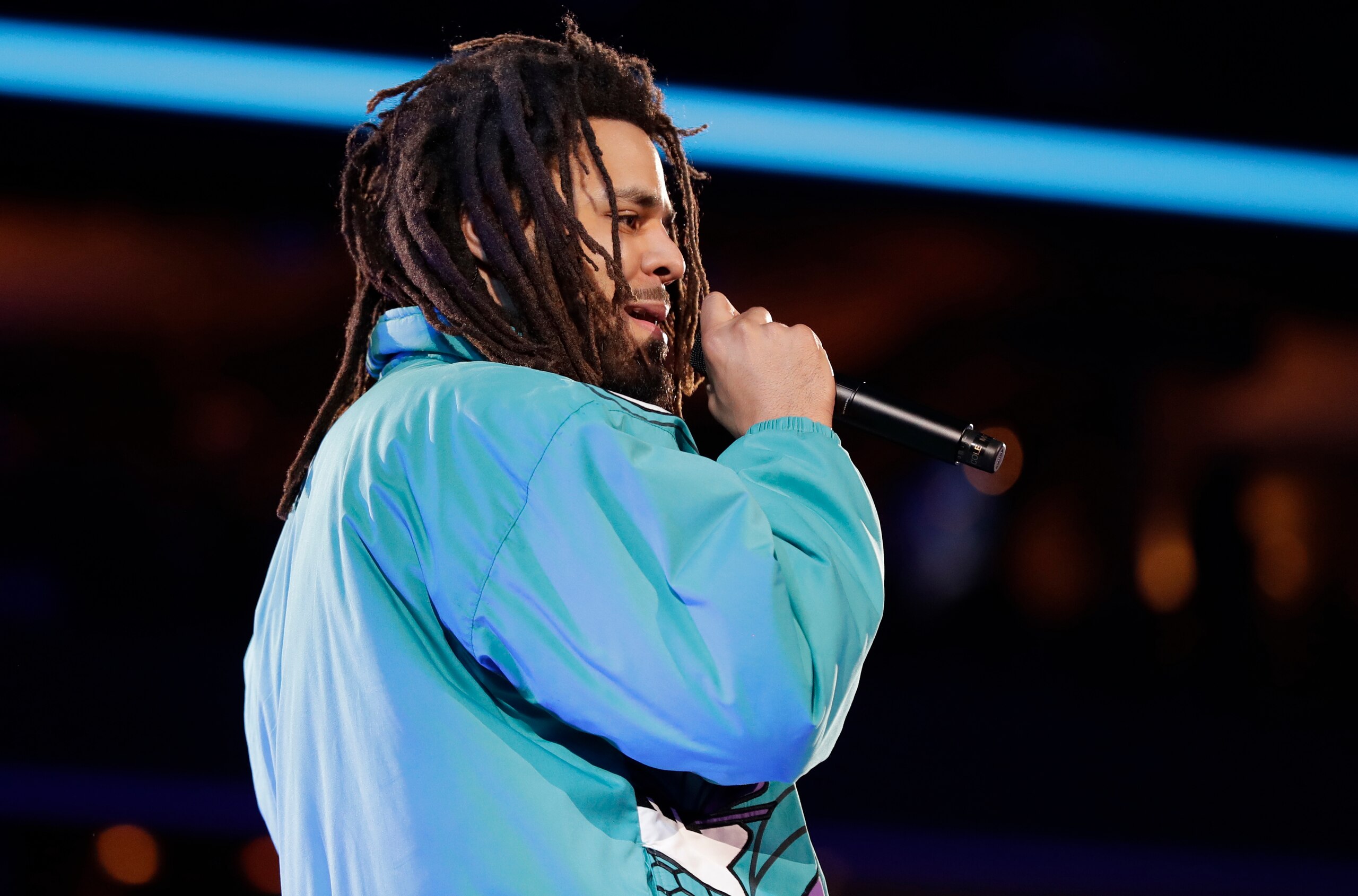 Rapper J. Cole performs at halftime during NBA All-Star basketball game, Sunday, Feb. 17, 2019, in Charlotte, N.C. (AP Photo/Chuck Burton)