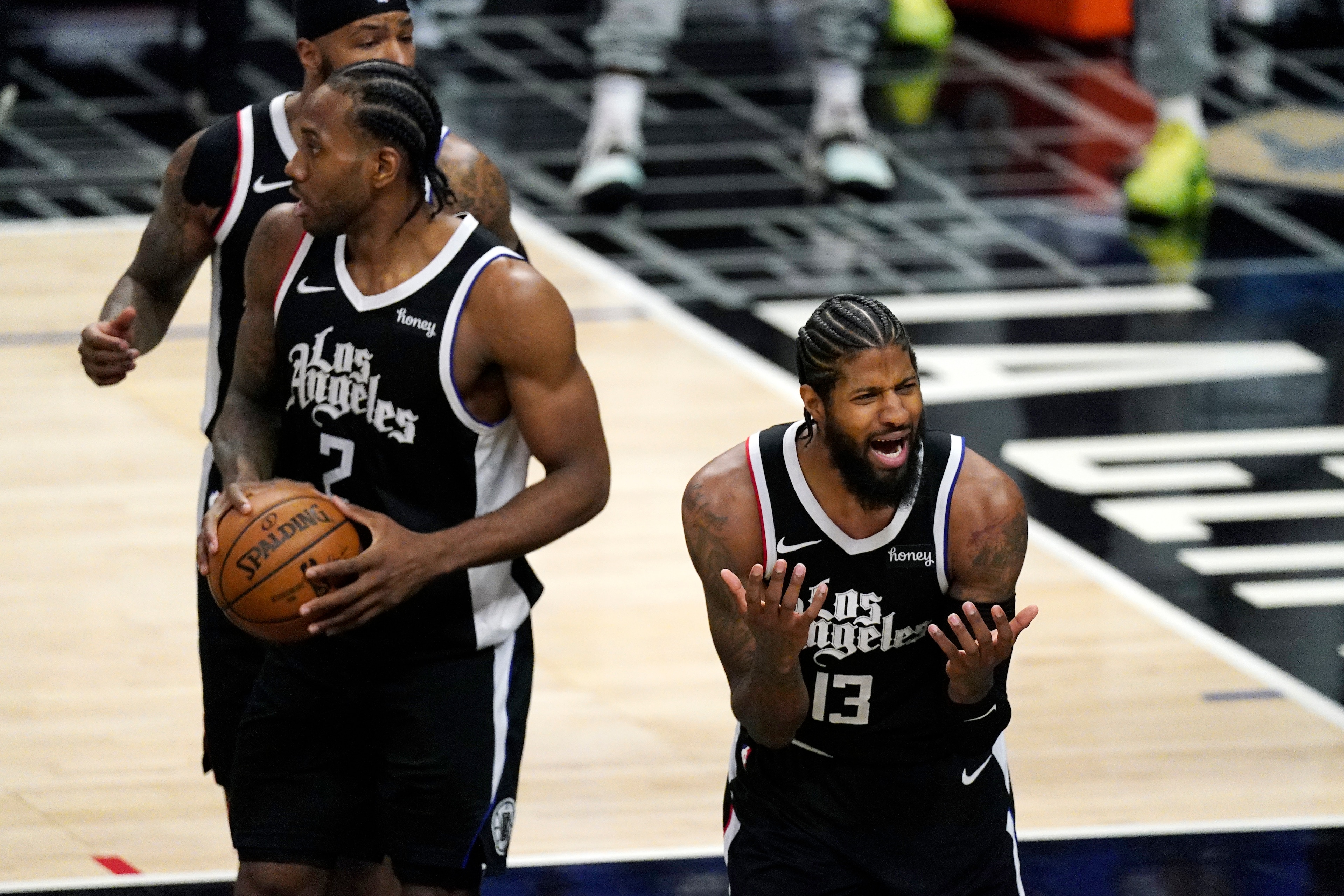 Los Angeles Clippers guard Paul George, right, complains about a call as forward Kawhi Leonard stands by during the second half in Game 1 of an NBA basketball first-round playoff series against the Dallas Mavericks Saturday, May 22, 2021, in Los Angeles. (AP Photo/Mark J. Terrill) Los Angeles Clippers guard Paul George, right, complains about a call as forward Kawhi Leonard stands by during the second half in Game 1 of an NBA basketball first-round playoff series against the Dallas Mavericks Saturday, May 22, 2021, in Los Angeles. (AP Photo/Mark J. Terrill)