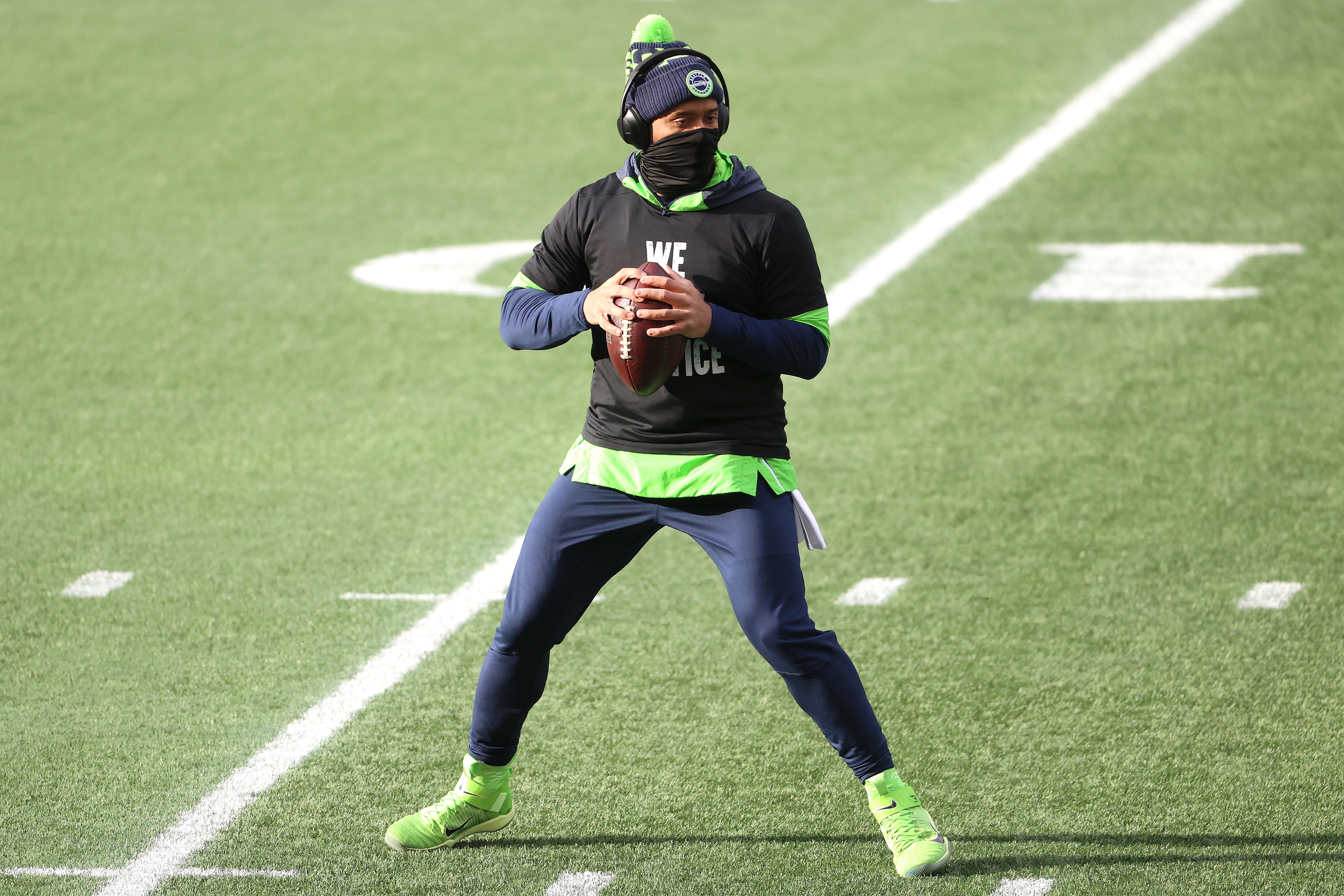 SEATTLE, WASHINGTON - JANUARY 09: Russell Wilson #3 of the Seattle Seahawks warms up before the NFC Wild Card Playoff game against the Los Angeles Rams at Lumen Field on January 09, 2021 in Seattle, Washington. (Photo by Abbie Parr/Getty Images)
