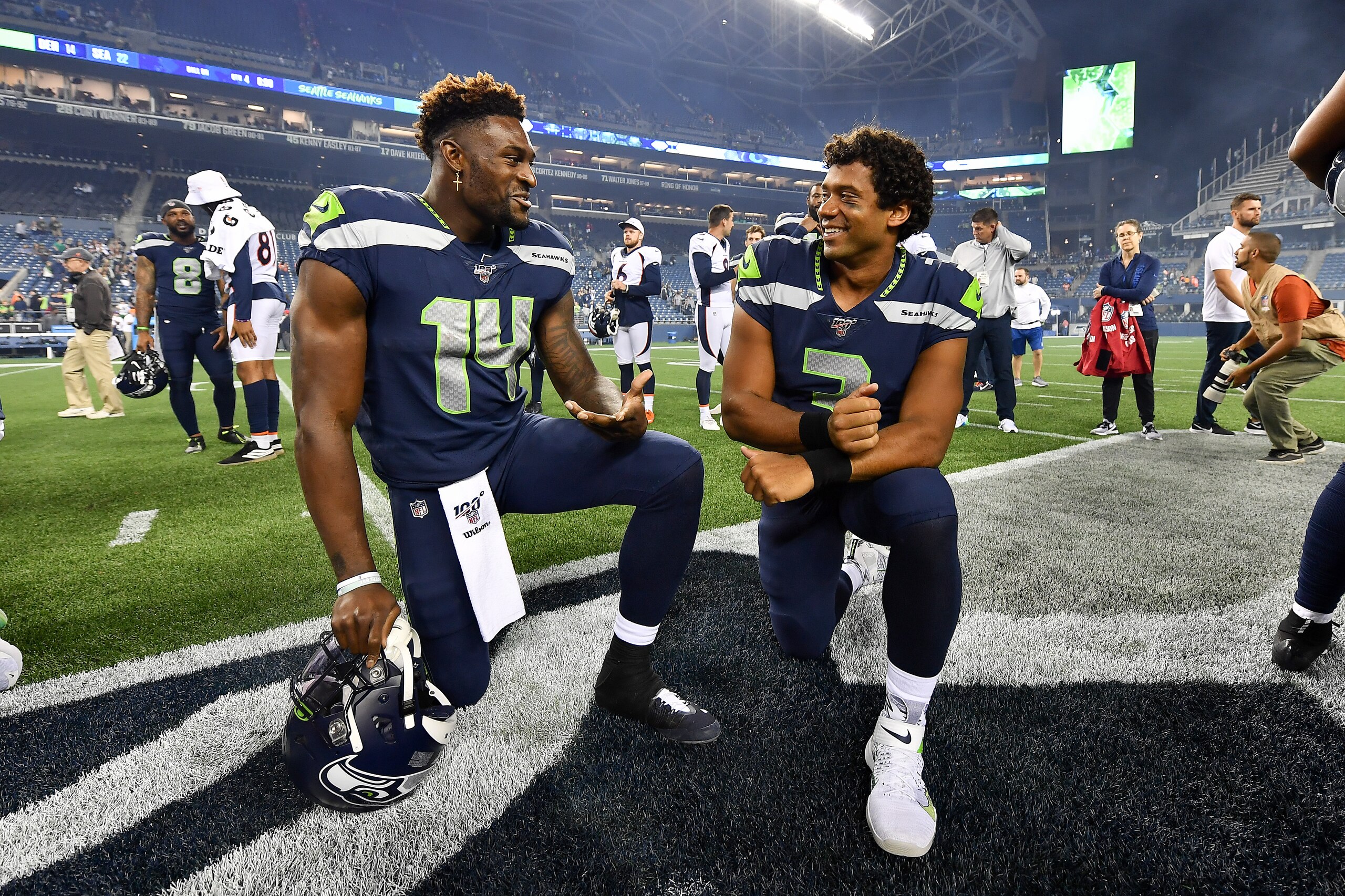 SEATTLE, WASHINGTON - AUGUST 08: D.K. Metcalf #14 and Russell Wilson #3 of the Seattle Seahawks have a chat after the preseason game victory over the Denver Broncos at CenturyLink Field on August 08, 2019 in Seattle, Washington. (Photo by Alika Jenner/Getty Images)