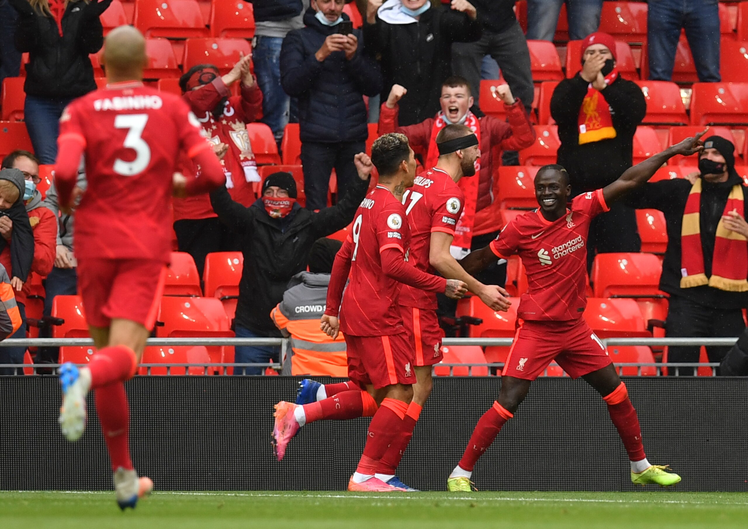 Liverpool's Sadio Mane, right, celebrates scoring his sides first goal during the English Premier League soccer match between Liverpool and Crystal Palace at Anfield stadium in Liverpool, England, Sunday, May 23, 2021. (Paul Ellis/Pool via AP)