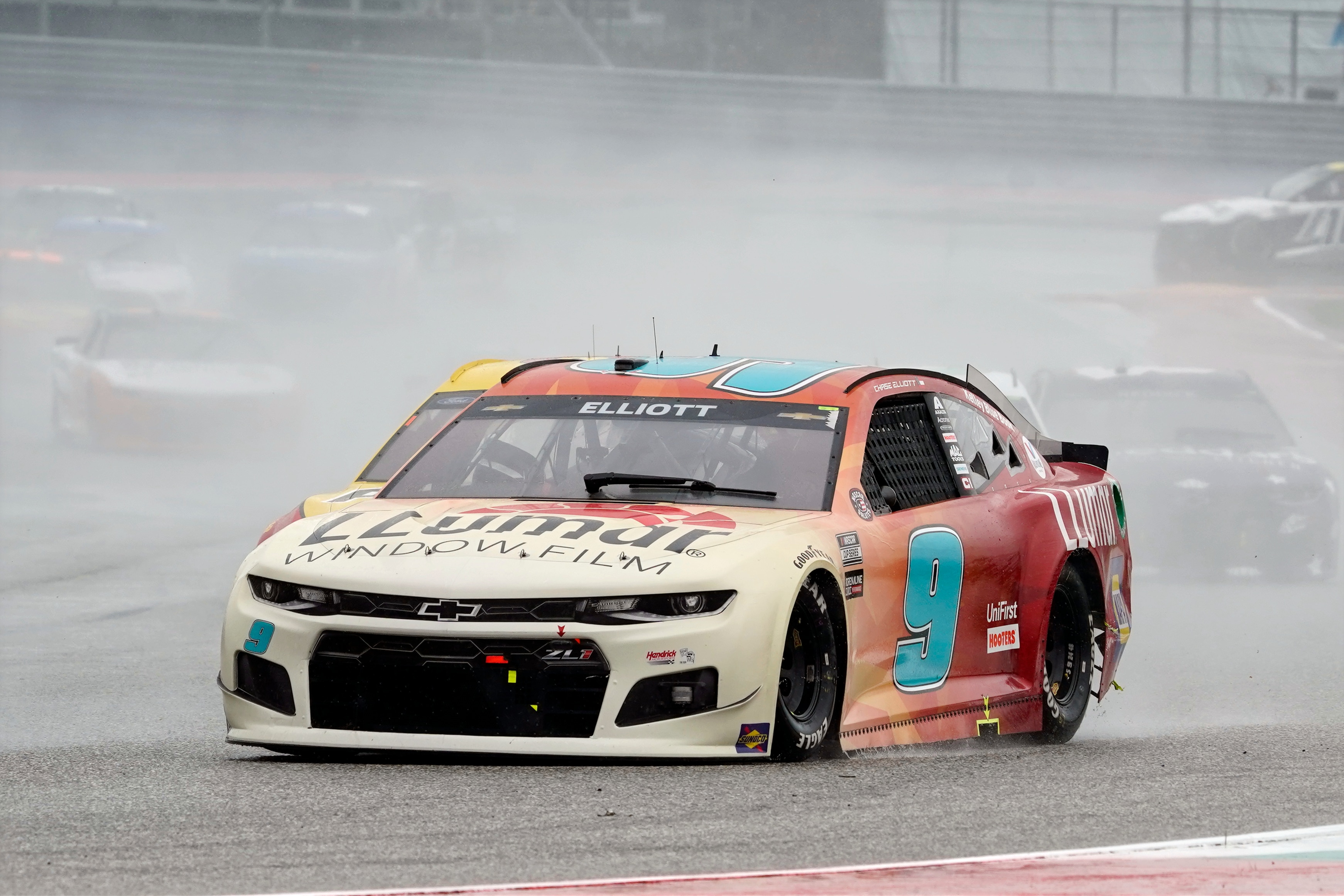 Chase Elliott (9) leads cars into Turn 13 during a NASCAR Cup Series auto race at Circuit of the Americas in Austin, Texas, Sunday, May 23, 2021. (AP Photo/Chuck Burton)
