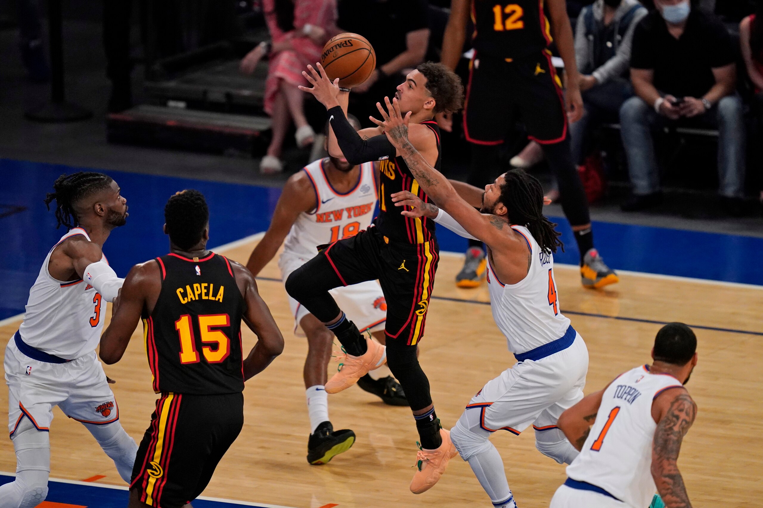 Atlanta Hawks' Trae Young, center, drives to the basket during the first half of Game 1 of an NBA basketball first-round playoff series against the New York Knicks, Sunday, May 23, 2021, in New York. (AP Photo/Seth Wenig, Pool)
