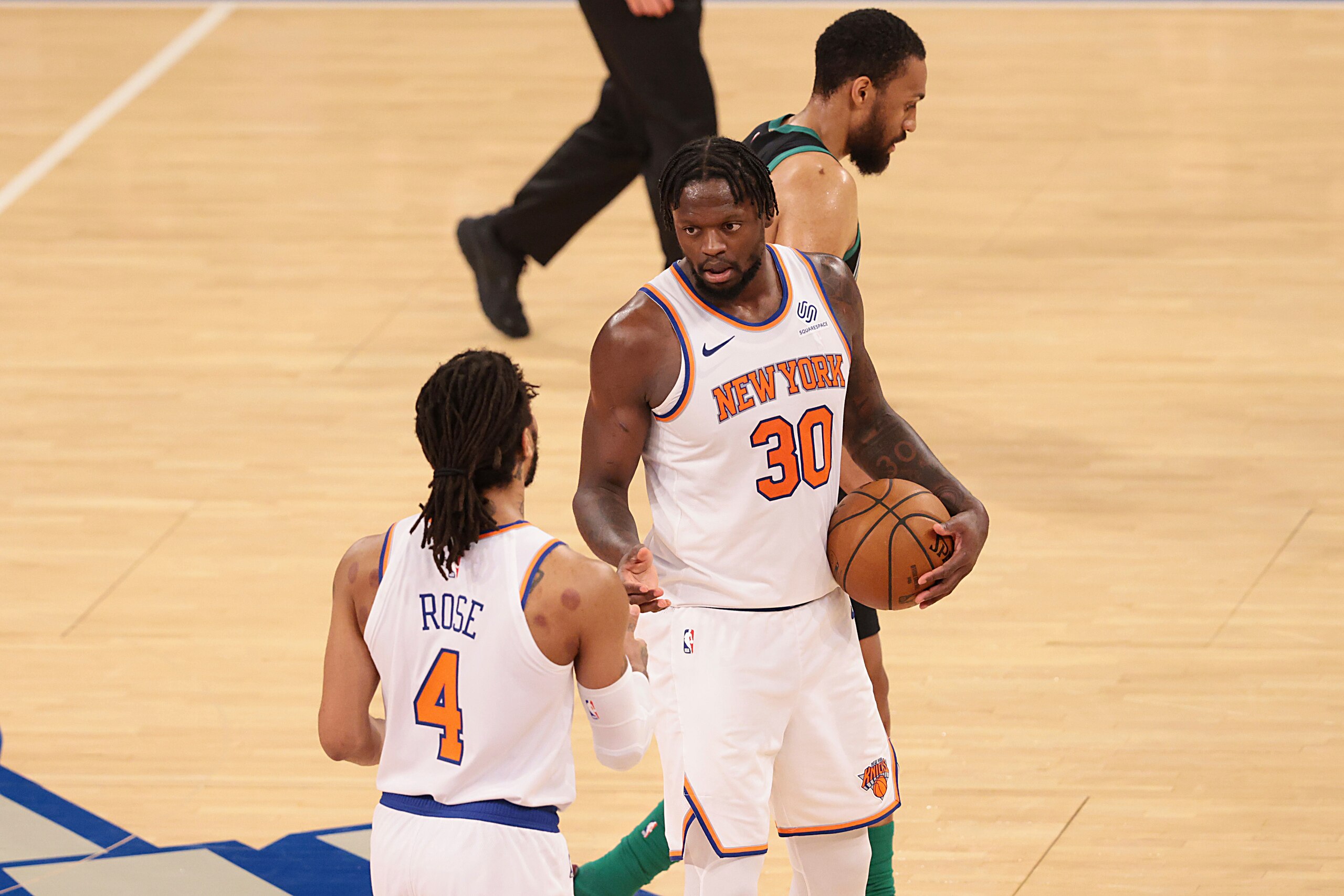 New York Knicks forward Julius Randle (30) celebrates with guard Derrick Rose (4) after an NBA basketball  game against the Boston Celtics in New York, Sunday, May 16, 2021. (Vincent Carchietta/Pool Photo via AP)