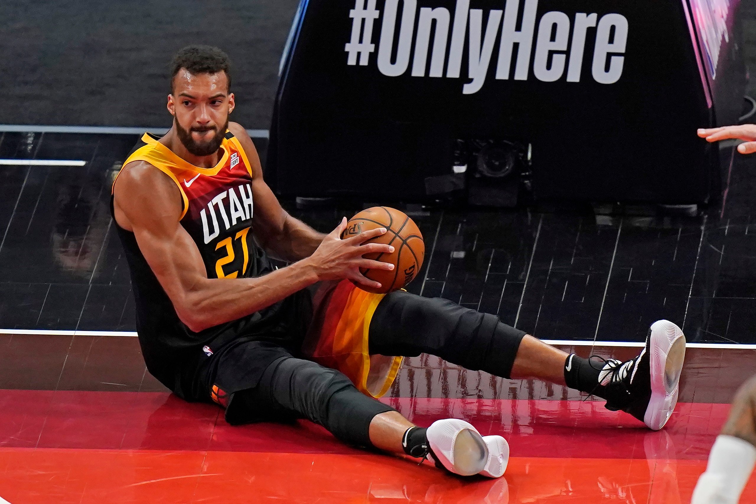 Utah Jazz center Rudy Gobert falls after pulling down a rebound during the first half of the team's NBA basketball game against the Portland Trail Blazers on Wednesday, May 12, 2021, in Salt Lake City. (AP Photo/Rick Bowmer)