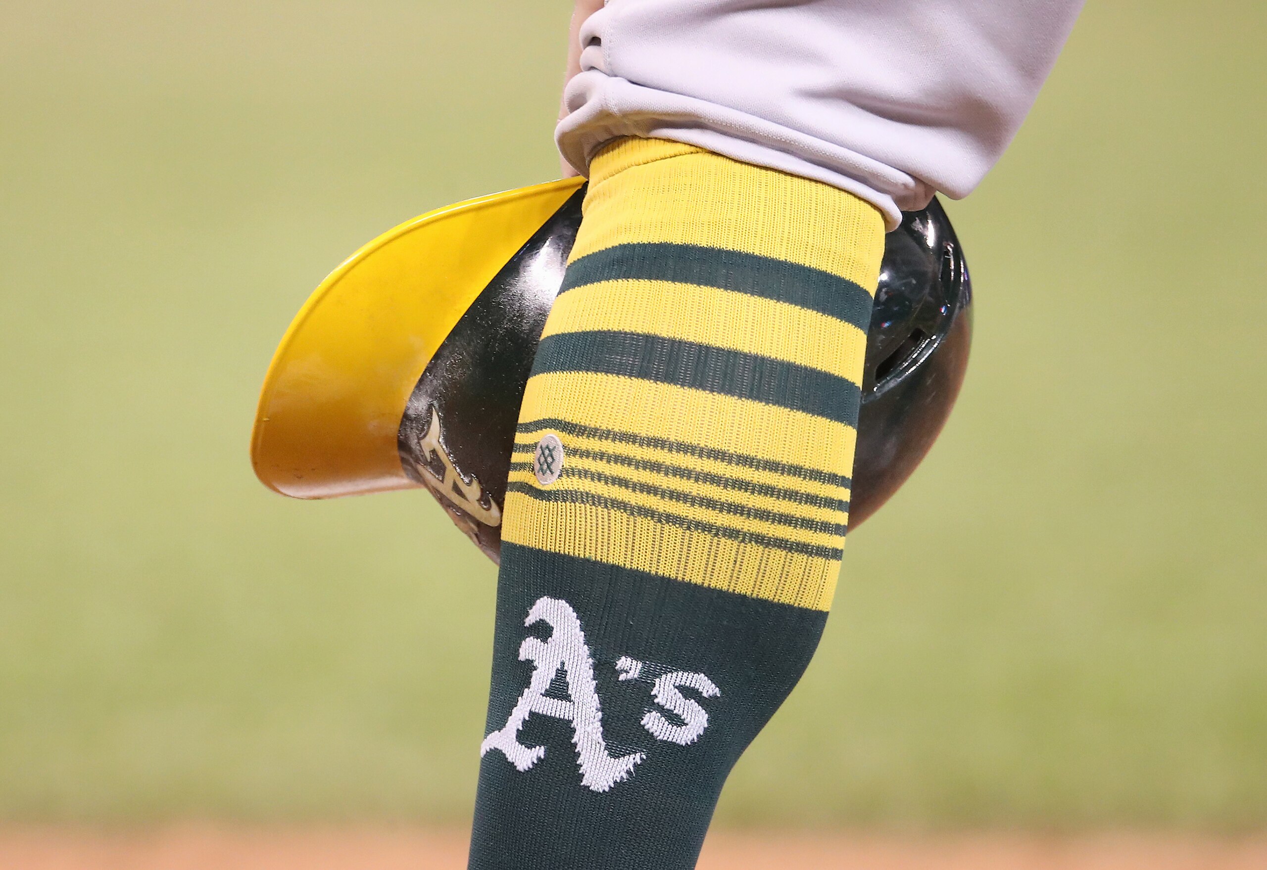 TORONTO, ON - APRIL 28: Robbie Grossman #8 of the Oakland Athletics waits during a pitching change as he rests his helmet beside his sock showing the team logo in the eleventh inning during MLB game action against the Toronto Blue Jays at Rogers Centre on April 28, 2019 in Toronto, Canada. (Photo by Tom Szczerbowski/Getty Images)