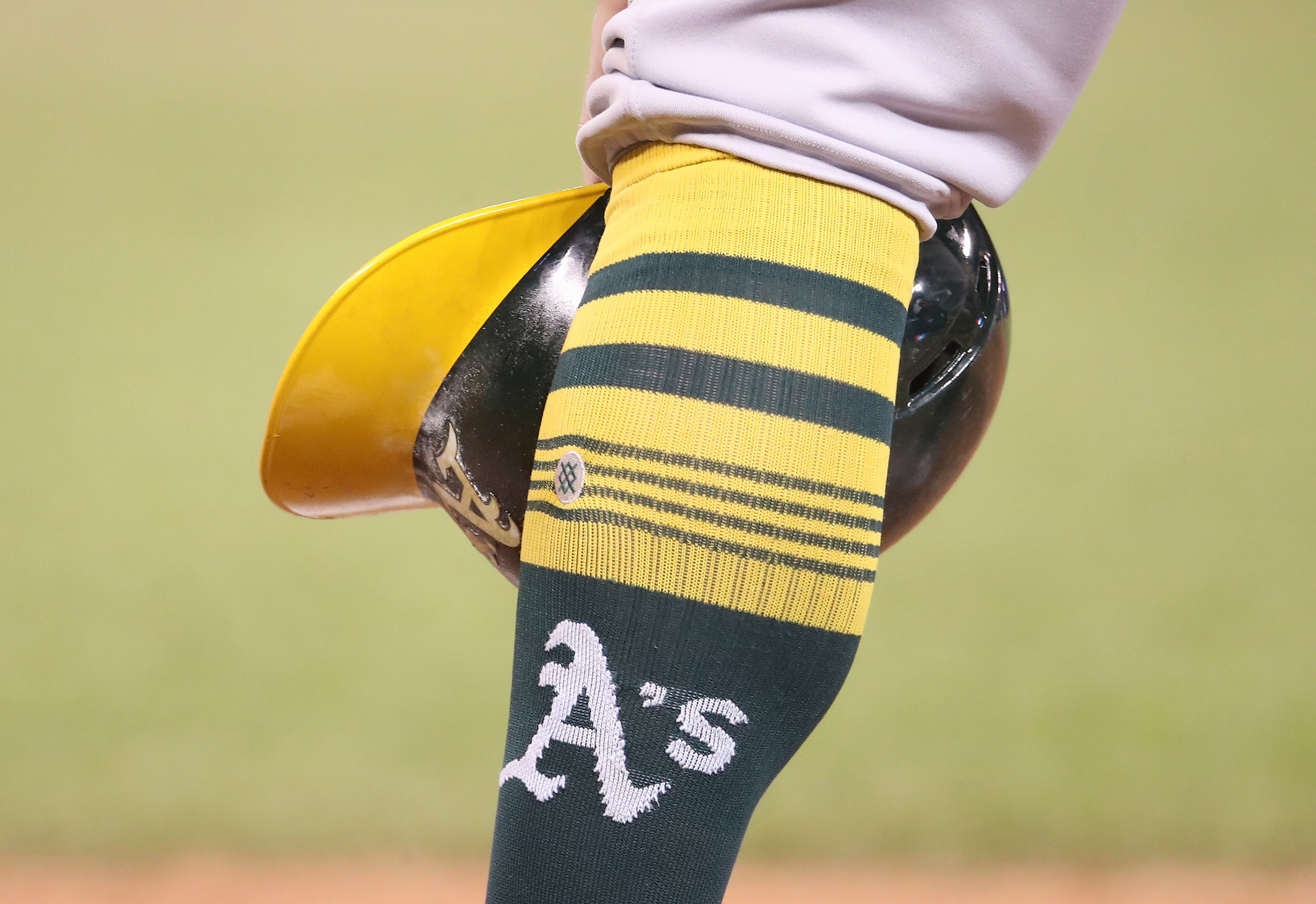 TORONTO, ON - APRIL 28: Robbie Grossman #8 of the Oakland Athletics waits during a pitching change as he rests his helmet beside his sock showing the team logo in the eleventh inning during MLB game action against the Toronto Blue Jays at Rogers Centre on April 28, 2019 in Toronto, Canada. (Photo by Tom Szczerbowski/Getty Images)