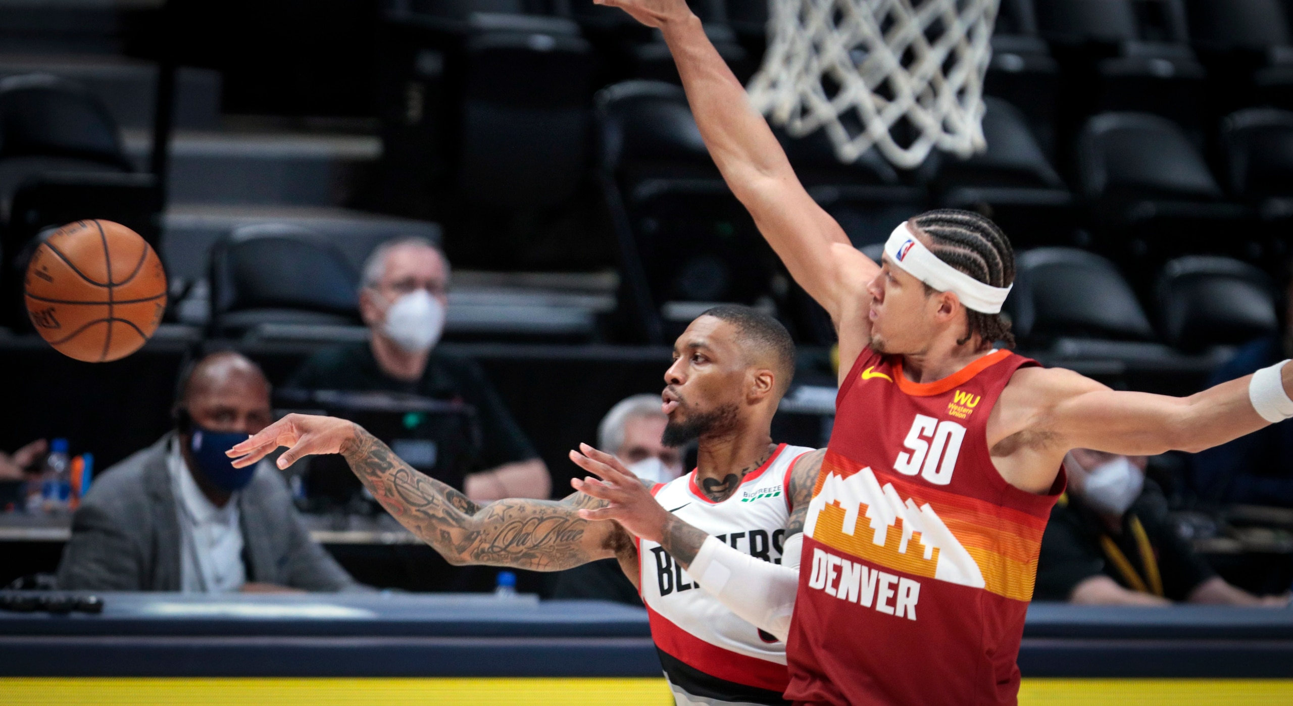 Portland Trail Blazers guard Damian Lillard (0) passes away from Denver Nuggets forward Aaron Gordon (50) in the third quarter of Game 2 of a first-round NBA basketball playoff series Monday, May 24, 2021, in Denver. (AP Photo/Joe Mahoney) Portland Trail Blazers guard Damian Lillard (0) passes away from Denver Nuggets forward Aaron Gordon (50) in the third quarter of Game 2 of a first-round NBA basketball playoff series Monday, May 24, 2021, in Denver. (AP Photo/Joe Mahoney)
