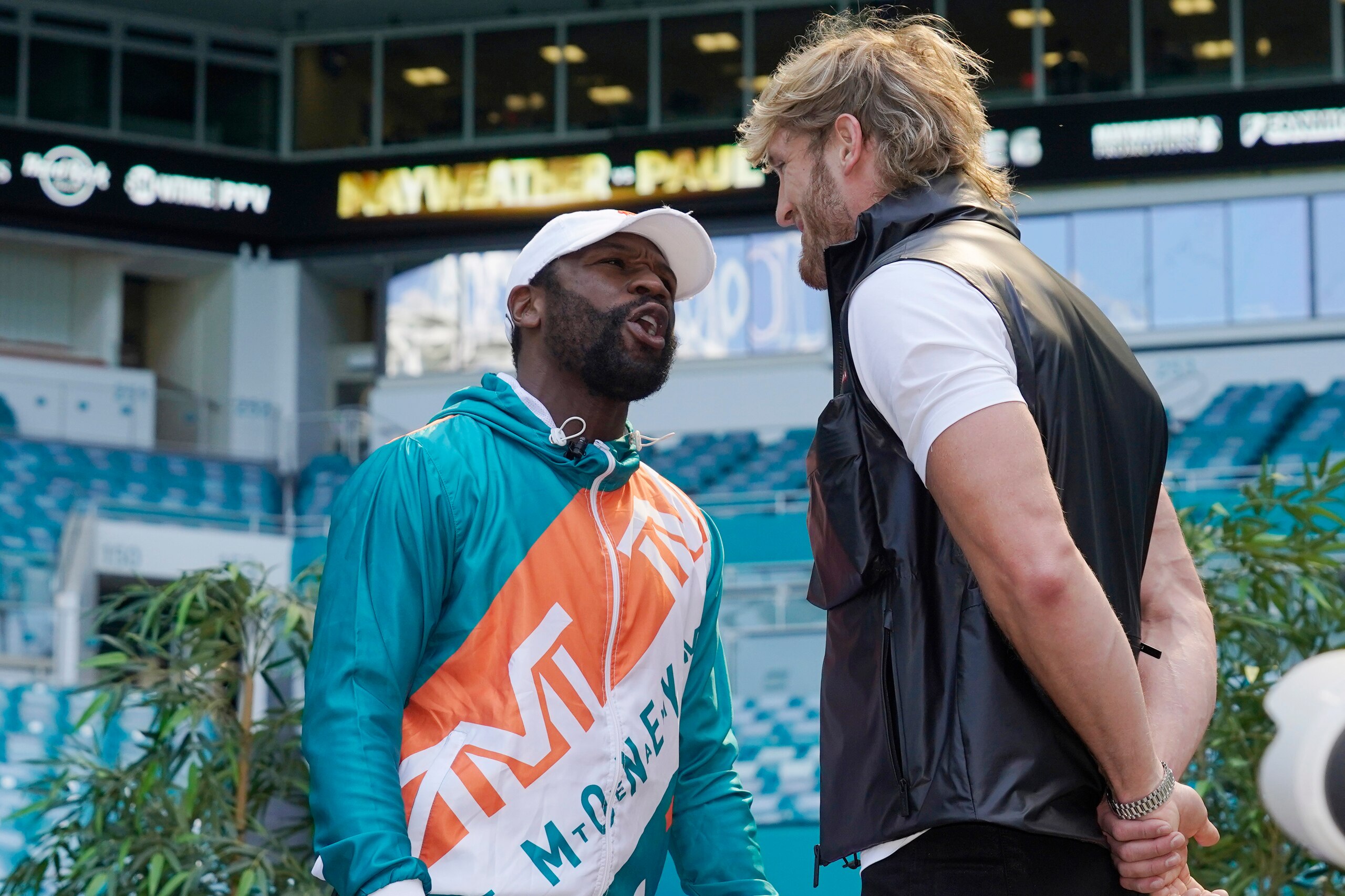 Boxers Floyd Mayweather and Logan Paul taunt each other during a news conference Thursday, May 6, 2021, in Miami Gardens, Fla. Mayweather and Paul are scheduled to face off in an exhibition bout June 6. (AP Photo/Marta Lavandier)