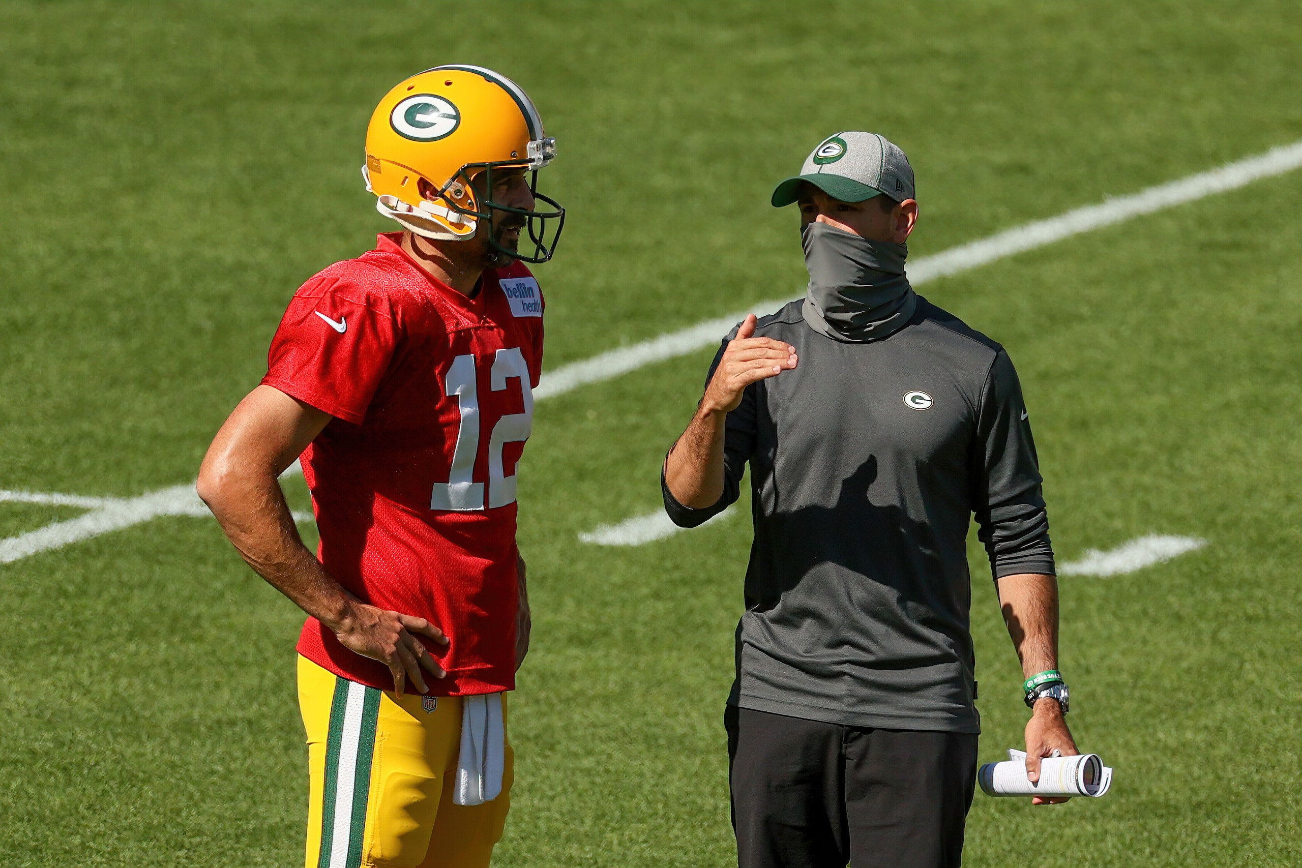 GREEN BAY, WISCONSIN - AUGUST 20: Aaron Rodgers #12 of the Green Bay Packers meets with head coach Matt LaFleur during Green Bay Packers Training Camp at Lambeau Field on August 20, 2020 in Green Bay, Wisconsin. (Photo by Dylan Buell/Getty Images)