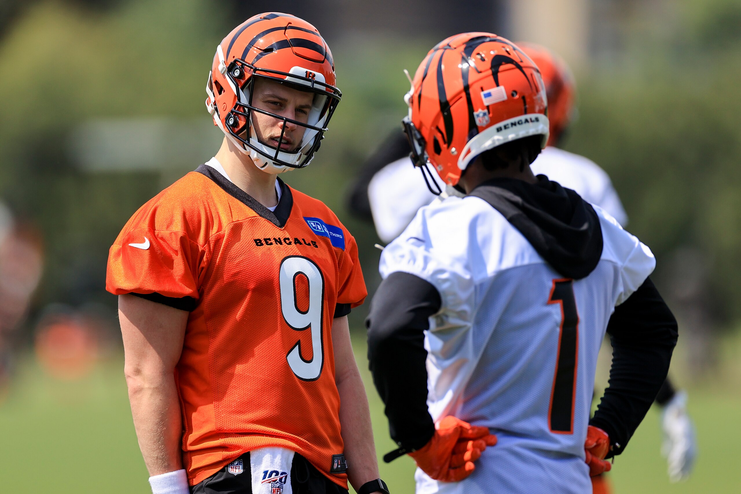 Cincinnati Bengals' Joe Burrow, left, talks with Ja'Marr Chase (1) during NFL football practice in Cincinnati, Tuesday, May 25, 2021. (AP Photo/Aaron Doster)
