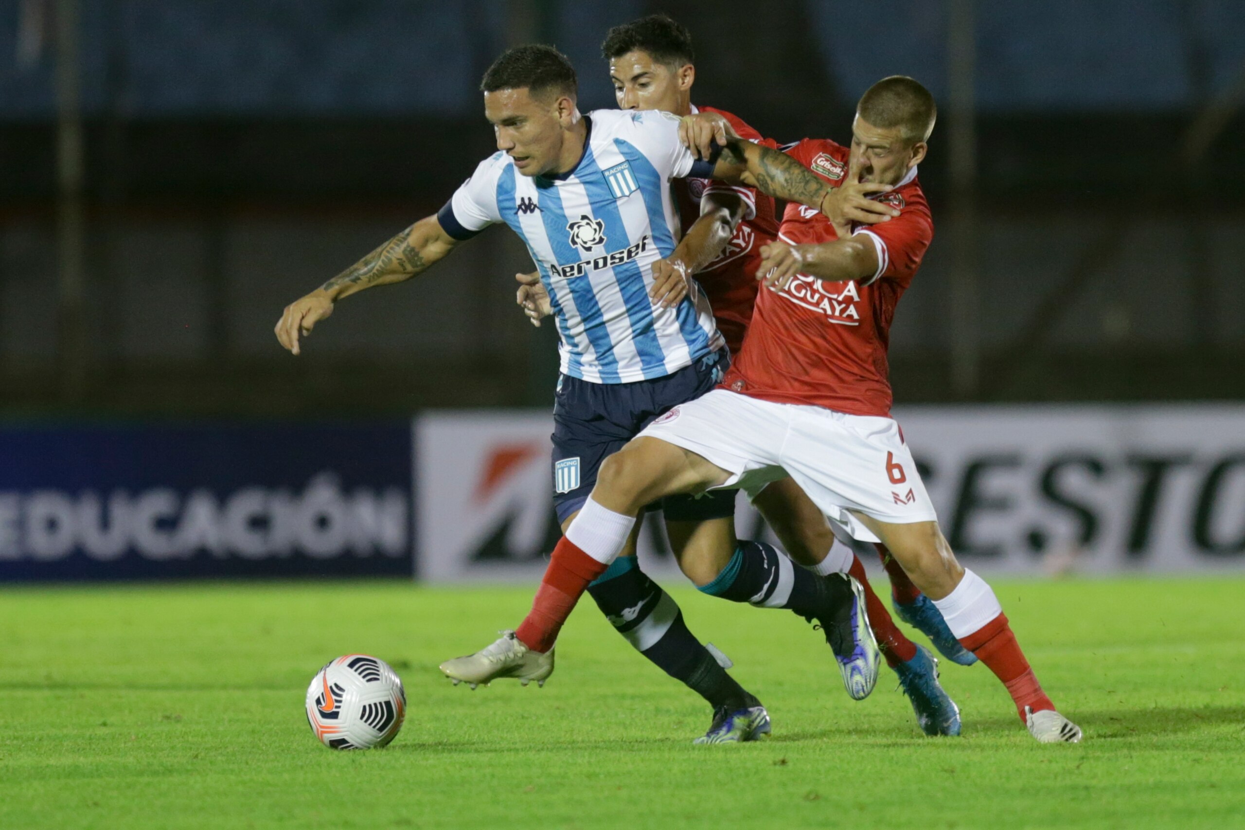 Enzo Copetti of Argentina's Racing, left, and Francisco Duarte of Uruguay's Rentistas battle for the ball during a Copa Libertadores soccer match in Montevideo, Uruguay, Wednesday, April 21, 2021.(AP Photo/Matilde Campodonico, Pool)