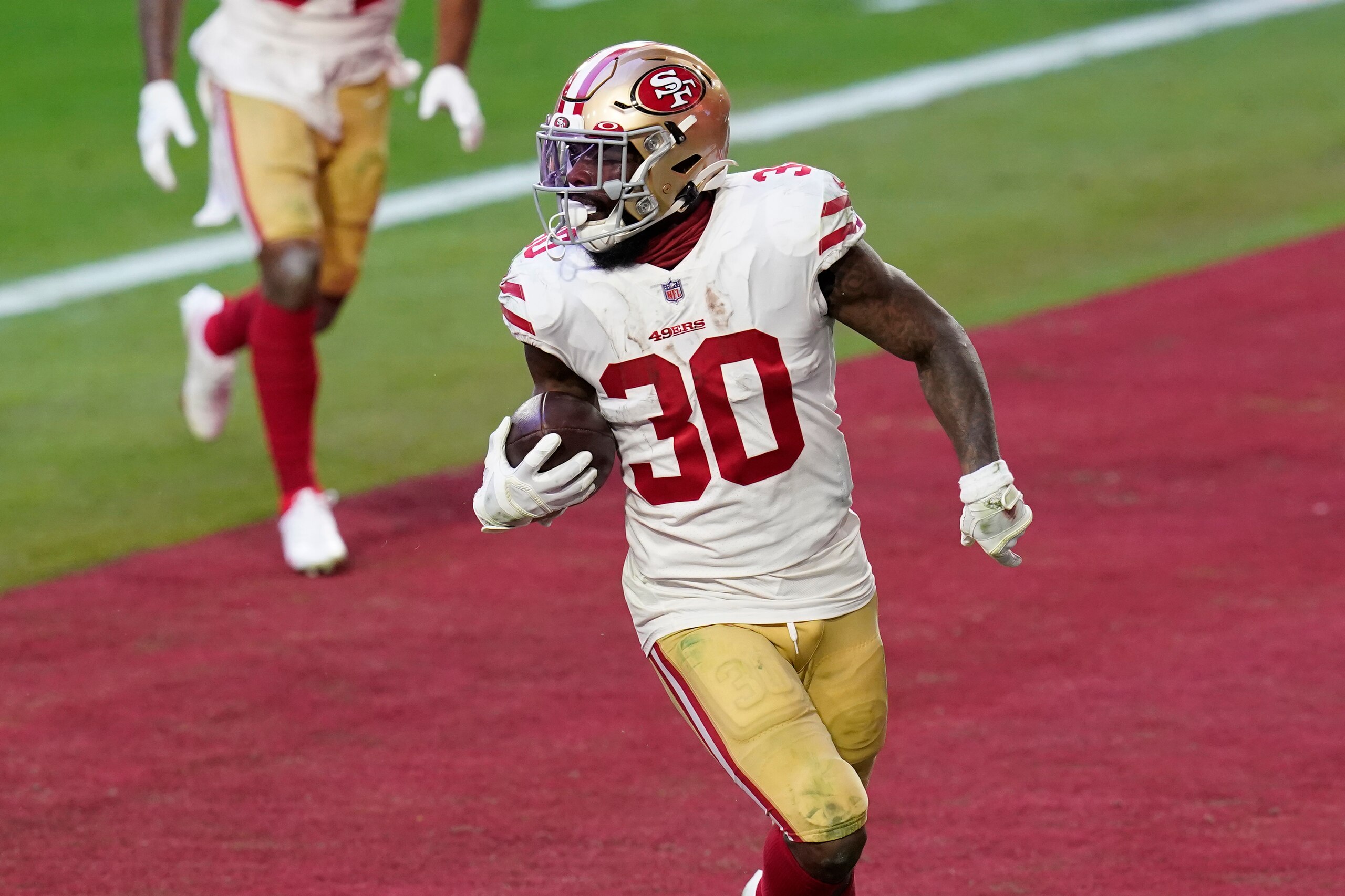 San Francisco 49ers running back Jeff Wilson (30) runs for a touchdown against the Seattle Seahawks during the second half of an NFL football game, Sunday, Jan. 3, 2021, in Glendale, Ariz. (AP Photo/Ross D. Franklin)