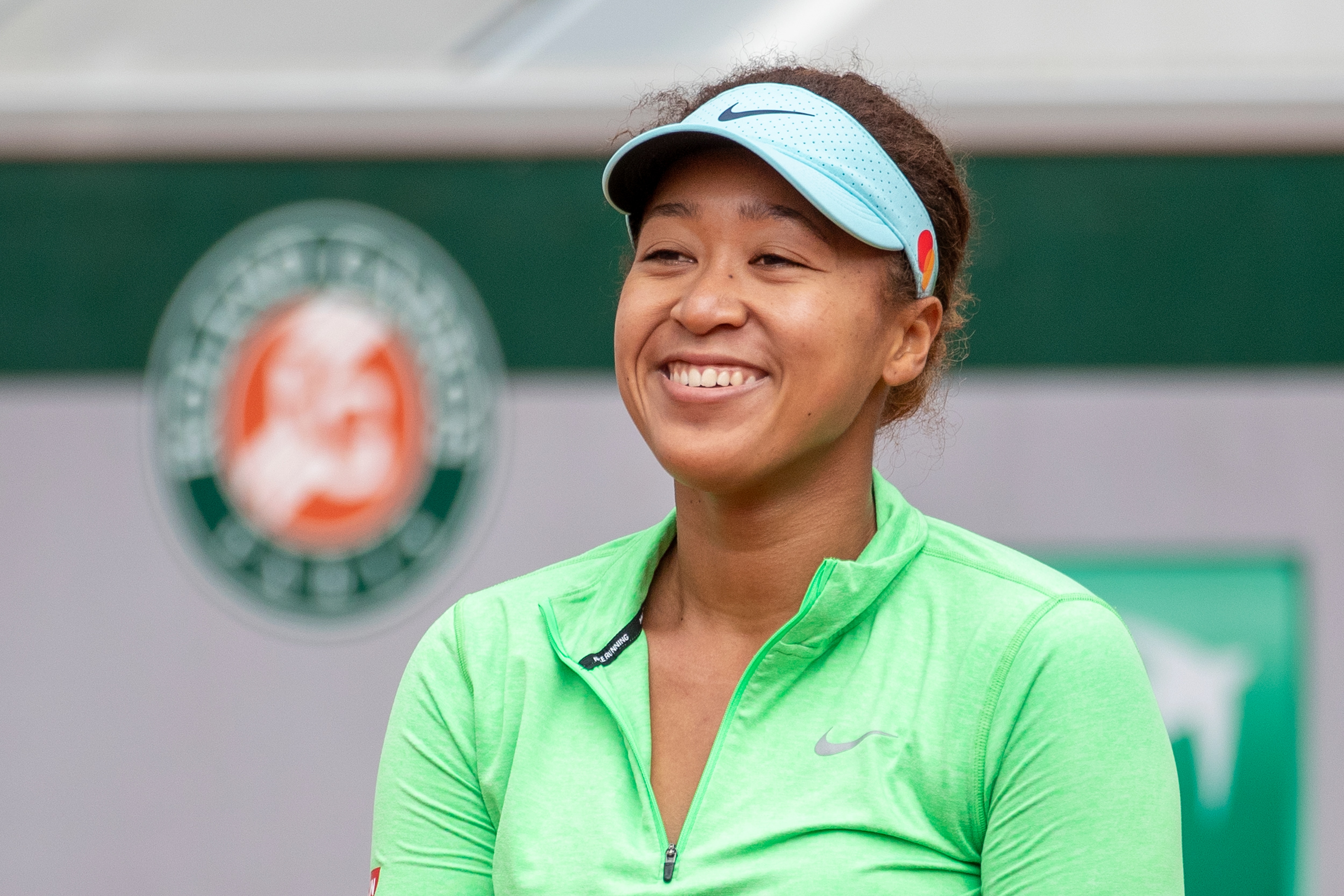 PARIS, FRANCE May 25. Naomi Osaka of Japan reacts during practice on Court Simonne Mathieu in preparation for the 2021 French Open Tennis Tournament at Roland Garros on May 25th 2021 in Paris, France. (Photo by Tim Clayton/Corbis via Getty Images)