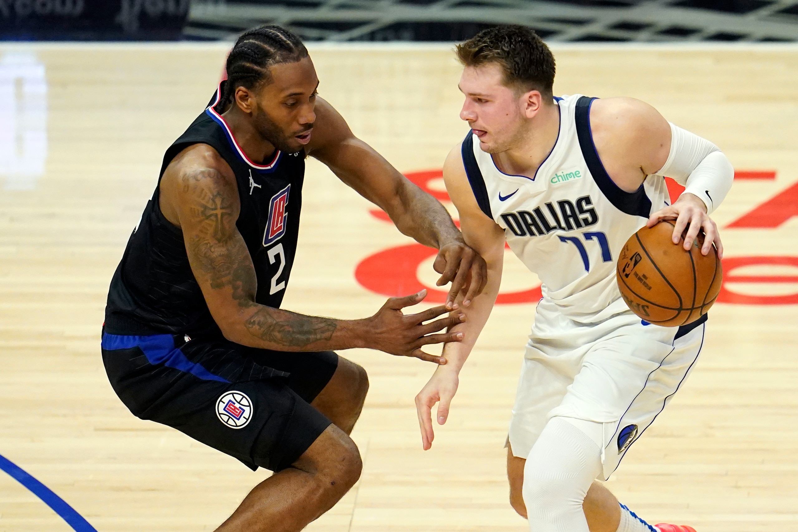 Dallas Mavericks guard Luka Doncic (77) is guarded by Los Angeles Clippers forward Kawhi Leonard (2) during the second half in Game 2 of an NBA basketball first-round playoff series Tuesday, May 25, 2021, in Los Angeles. (AP Photo/Marcio Jose Sanchez)
