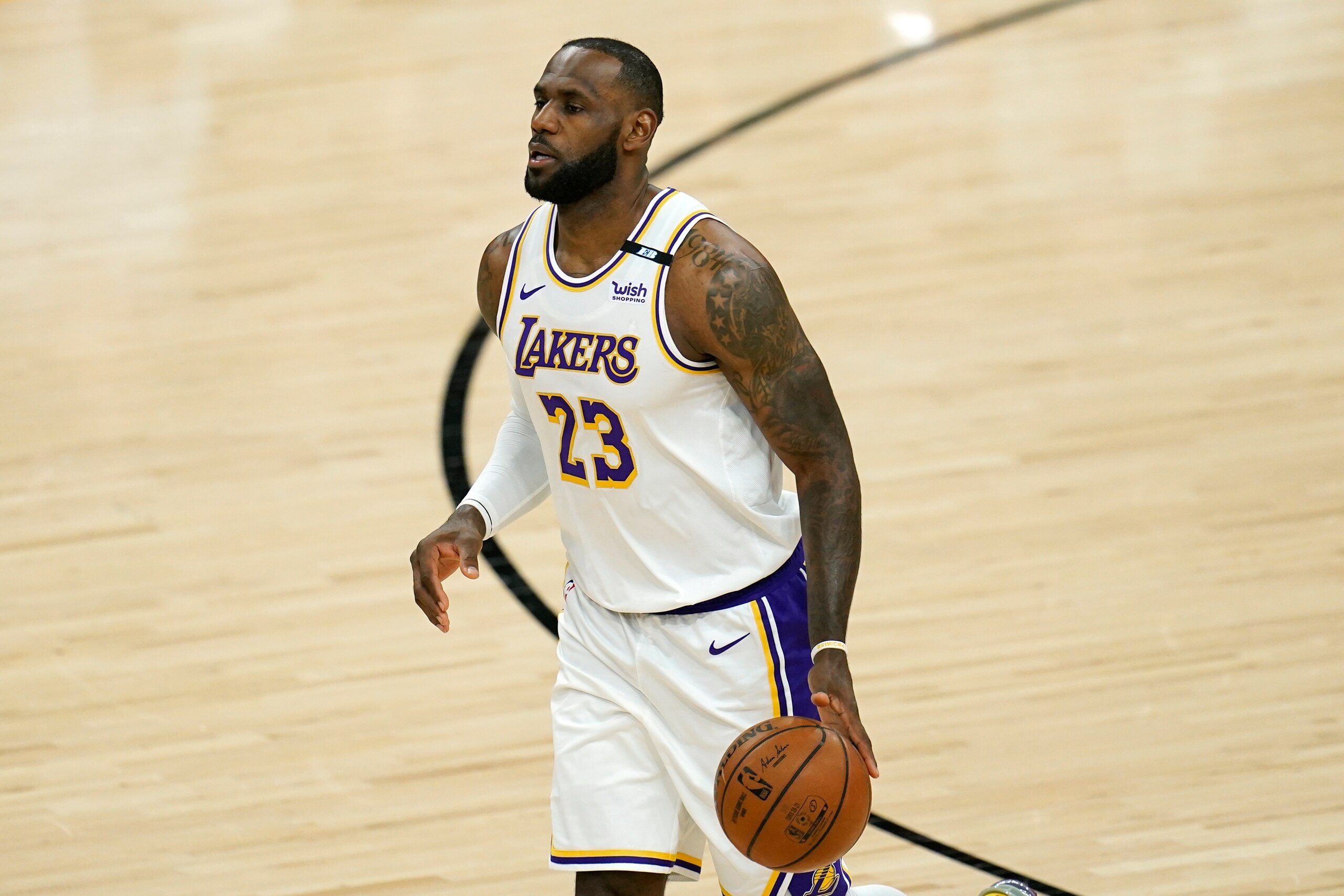 Los Angeles Lakers forward LeBron James dribbles the ball against the Phoenix Suns during the first half of Game 1 of their NBA basketball first-round playoff series Sunday, May 23, 2021, in Phoenix. (AP Photo/Ross D. Franklin)
