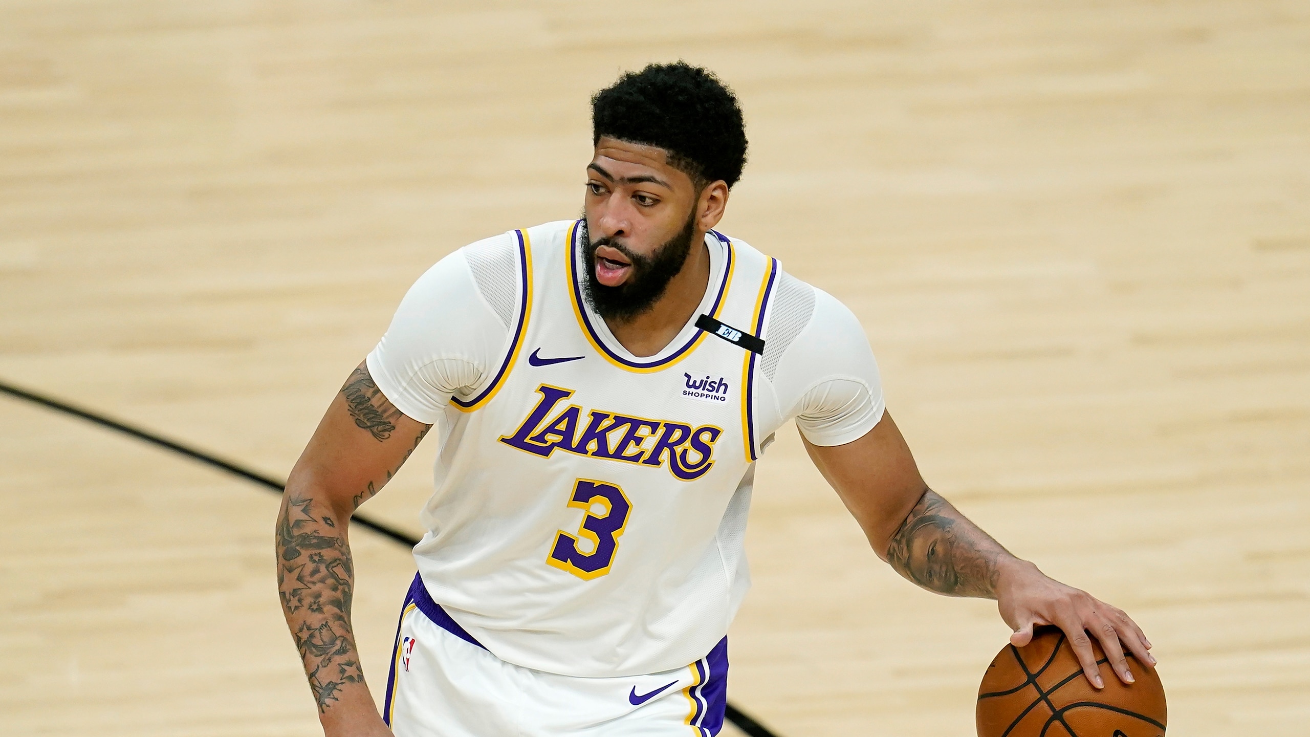 Los Angeles Lakers forward Anthony Davis dribbles the ball against the Phoenix Suns during the first half of Game 1 of their NBA basketball first-round playoff series Sunday, May 23, 2021, in Phoenix. (AP Photo/Ross D. Franklin)