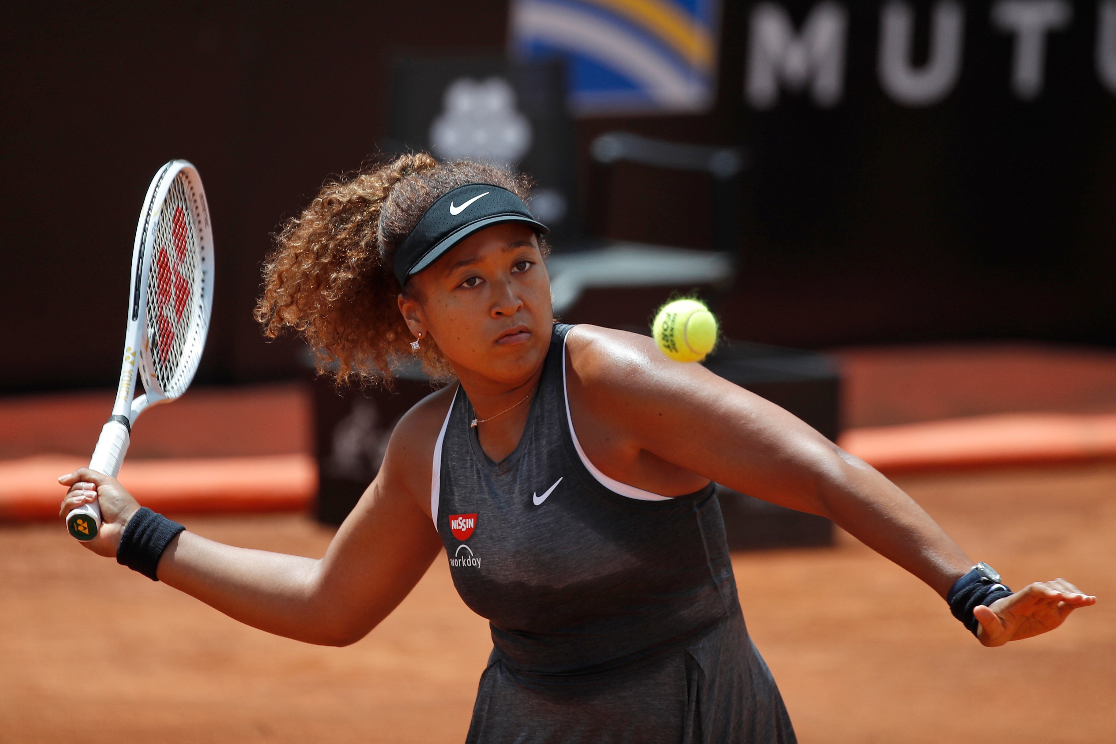 Naomi Osaka of Japan returns the ball to Jessica Pegula of the United States during their match at the Italian Open tennis tournament, in Rome, Wednesday, May 12, 2021. Osaka lost against Pegula 7-6, 6-2. (AP Photo/Alessandra Tarantino)