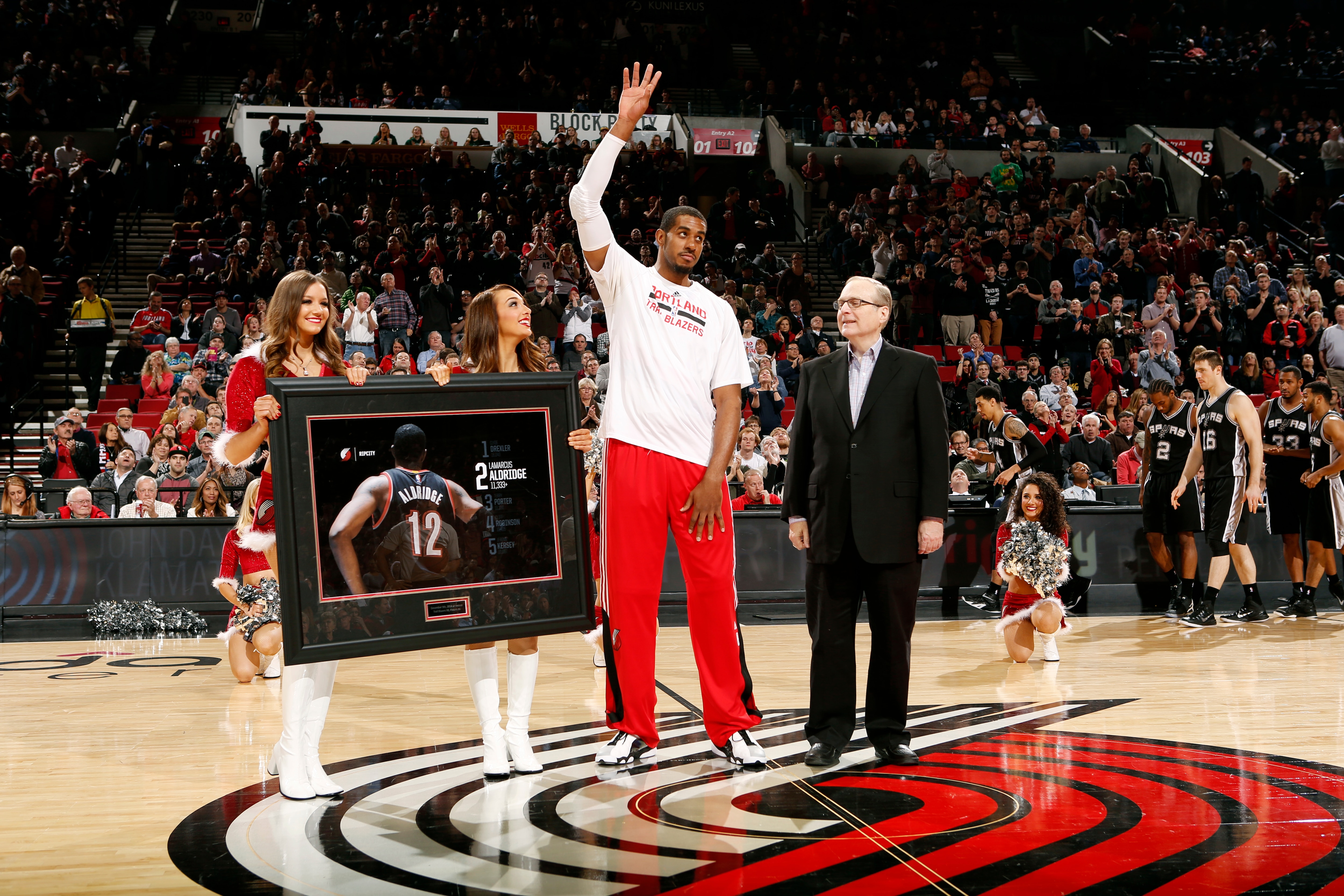 PORTLAND, OR - DECEMBER 15: LaMarcus Aldridge #12 of the Portland Trail Blazers receives an award from team owner Paul Allen for now being second on the teams all time scoring list before a game against the San Antonio Spurs on December 15, 2014 at the Moda Center Arena in Portland, Oregon. NOTE TO USER: User expressly acknowledges and agrees that, by downloading and or using this photograph, user is consenting to the terms and conditions of the Getty Images License Agreement. Mandatory Copyright Notice: Copyright 2014 NBAE (Photo by Cameron Browne/NBAE via Getty Images)