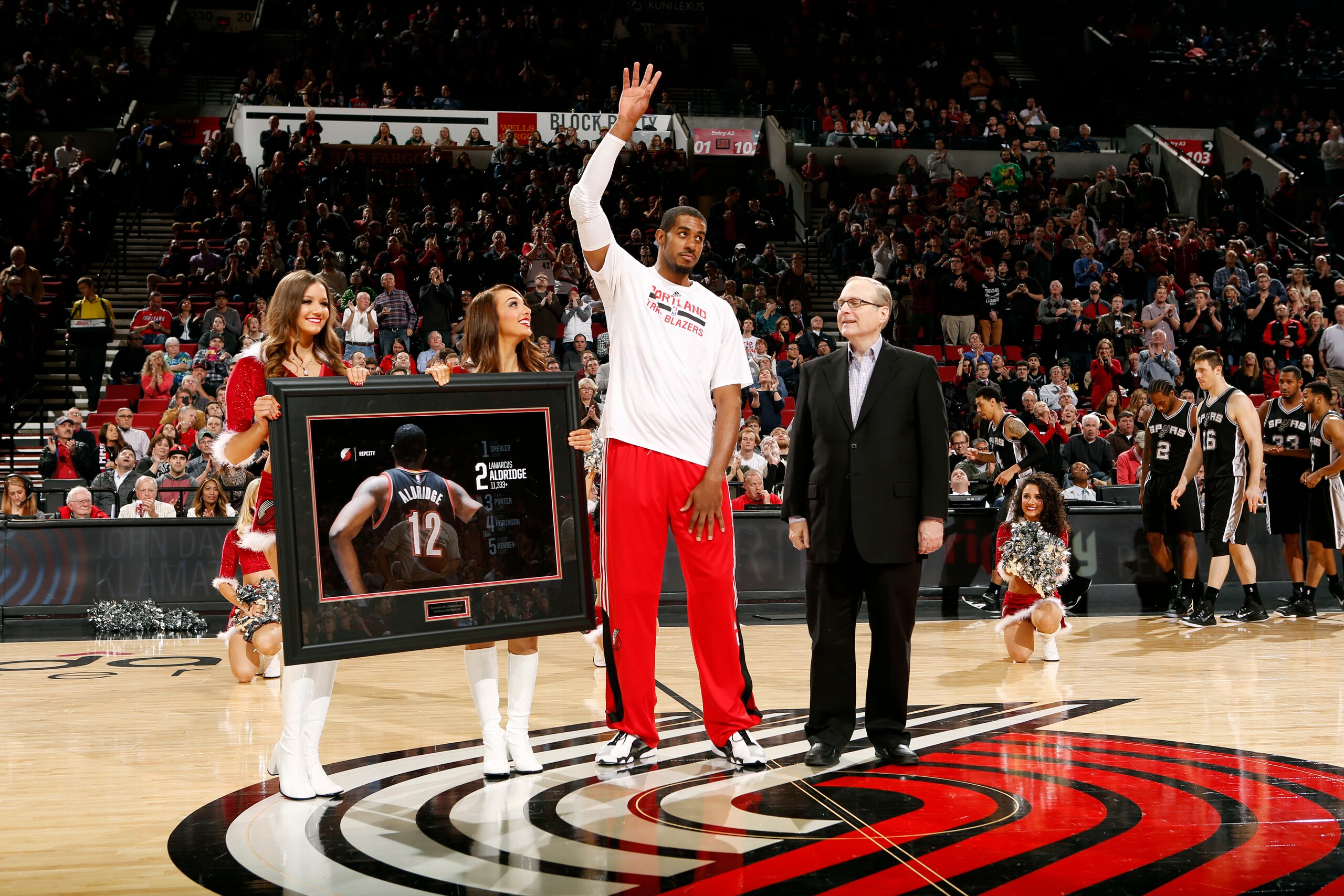 PORTLAND, OR - DECEMBER 15: LaMarcus Aldridge #12 of the Portland Trail Blazers receives an award from team owner Paul Allen for now being second on the teams all time scoring list before a game against the San Antonio Spurs on December 15, 2014 at the Moda Center Arena in Portland, Oregon. NOTE TO USER: User expressly acknowledges and agrees that, by downloading and or using this photograph, user is consenting to the terms and conditions of the Getty Images License Agreement. Mandatory Copyright Notice: Copyright 2014 NBAE (Photo by Cameron Browne/NBAE via Getty Images)