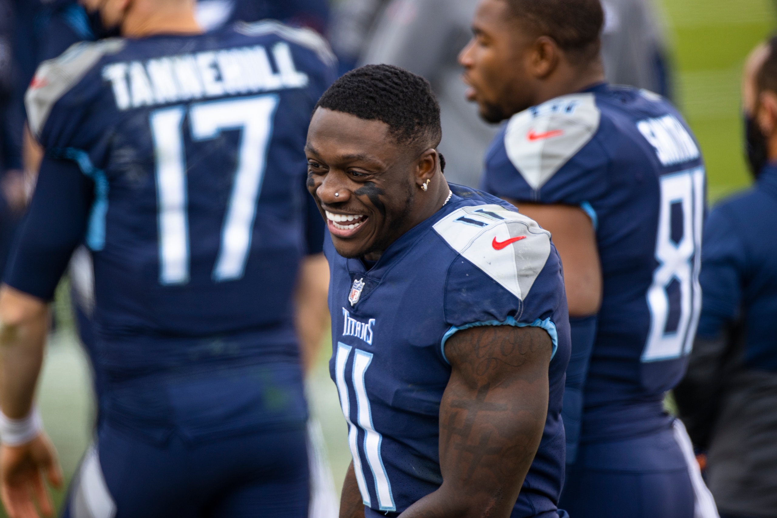 Tennessee Titans wide receiver A.J. Brown (11) laughs on the sideline with teammates during the fourth quarter of an NFL wild-card playoff football game against the Baltimore Ravens, Sunday, Jan. 10, 2021, in Nashville, Tenn. Ravens defeat Titans 20-13. (AP Photo/Brett Carlsen)