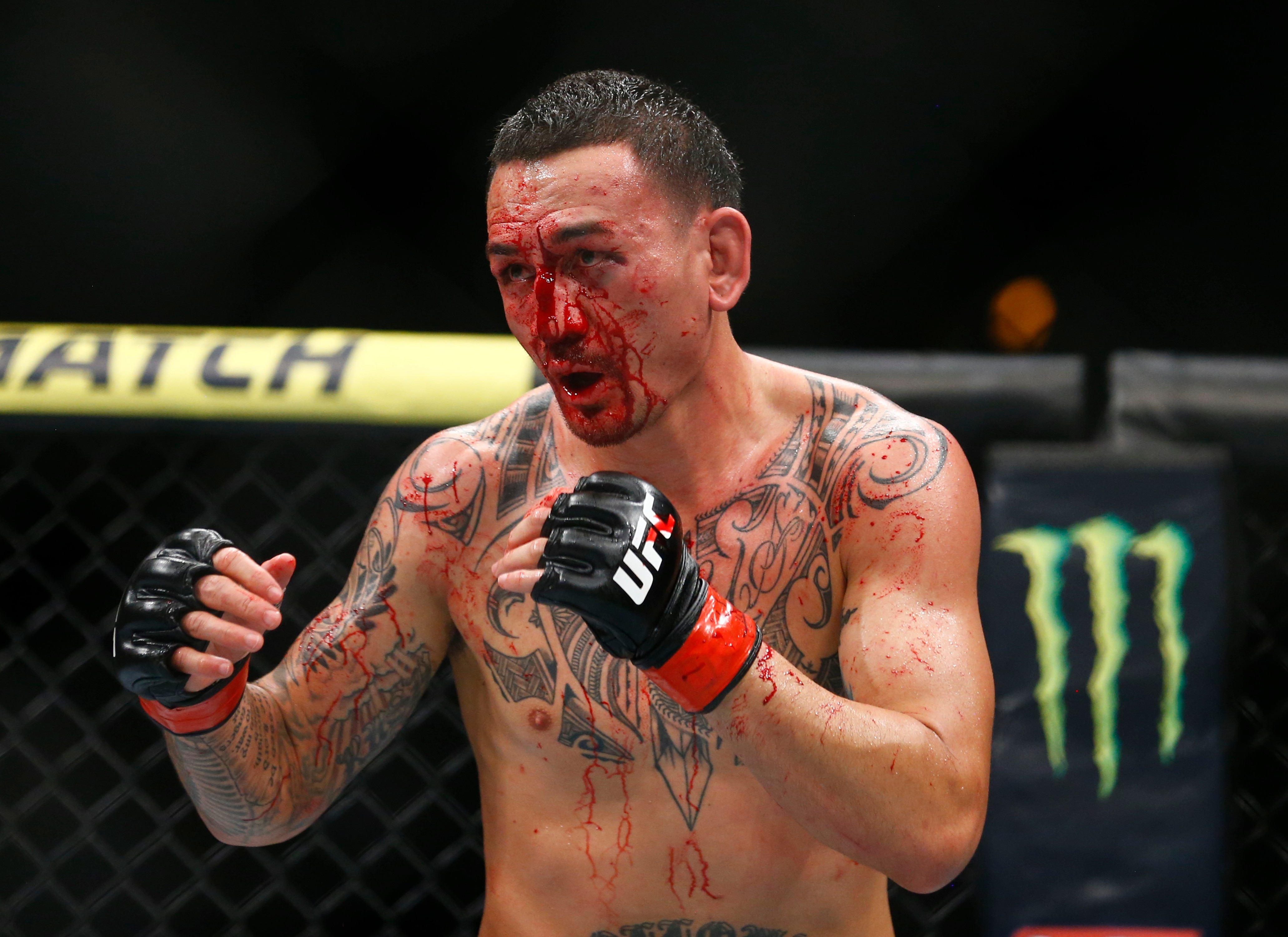 Max Holloway fights Dustin Poirier during an interim lightweight title mixed martial arts bout at UFC 236 in Atlanta, early Sunday, April 14, 2019. (AP Photo/Michael Zarrilli)