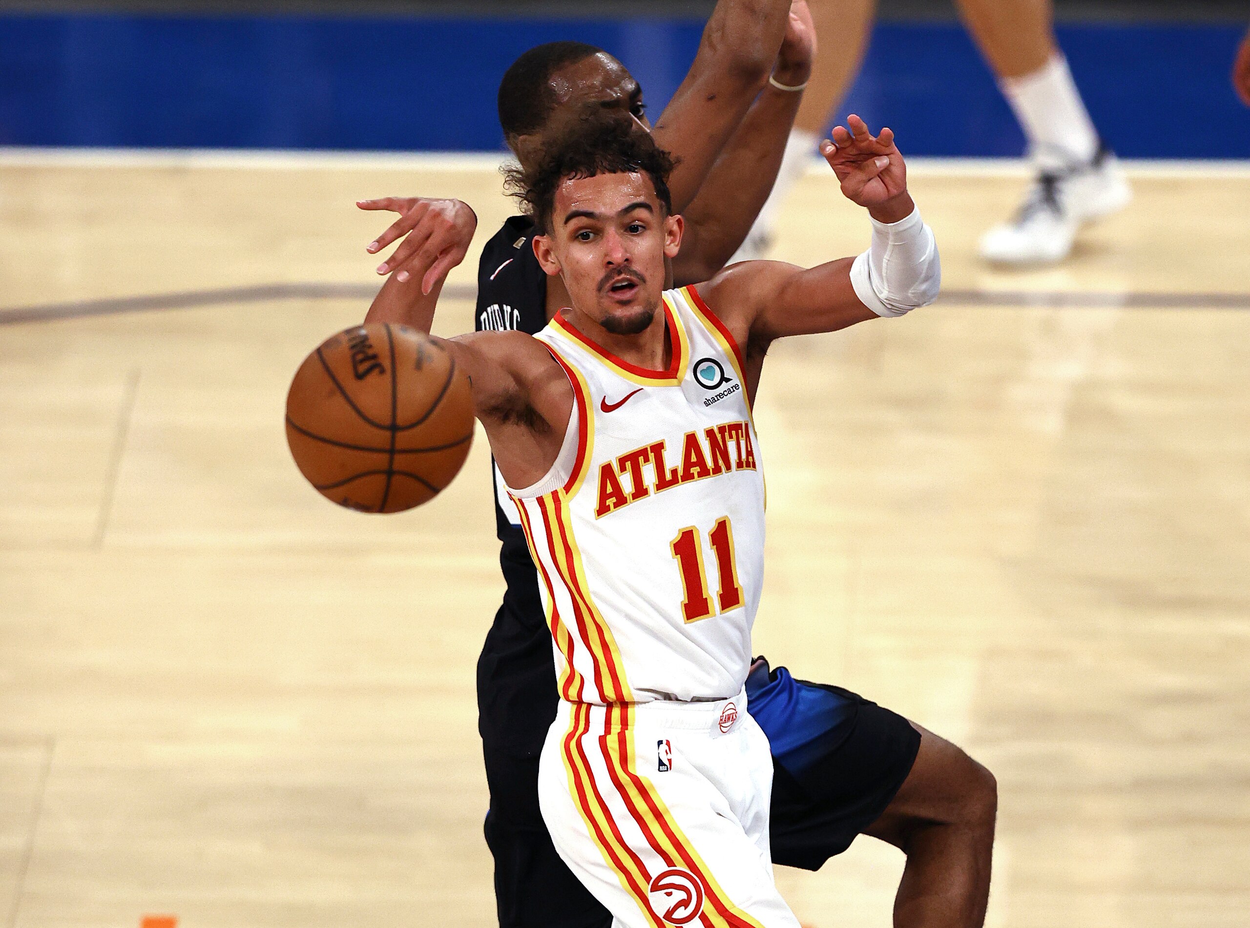 Atlanta Hawks' Trae Young (11) passes the ball as New York Knicks' Alec Burks defends during the fourth quarter in Game 2 in an NBA basketball first-round playoff series Wednesday, May 26, 2021, in New York. (Elsa/Pool Photo via AP) Atlanta Hawks' Trae Young (11) passes the ball as New York Knicks' Alec Burks defends during the fourth quarter in Game 2 in an NBA basketball first-round playoff series Wednesday, May 26, 2021, in New York. (Elsa/Pool Photo via AP)