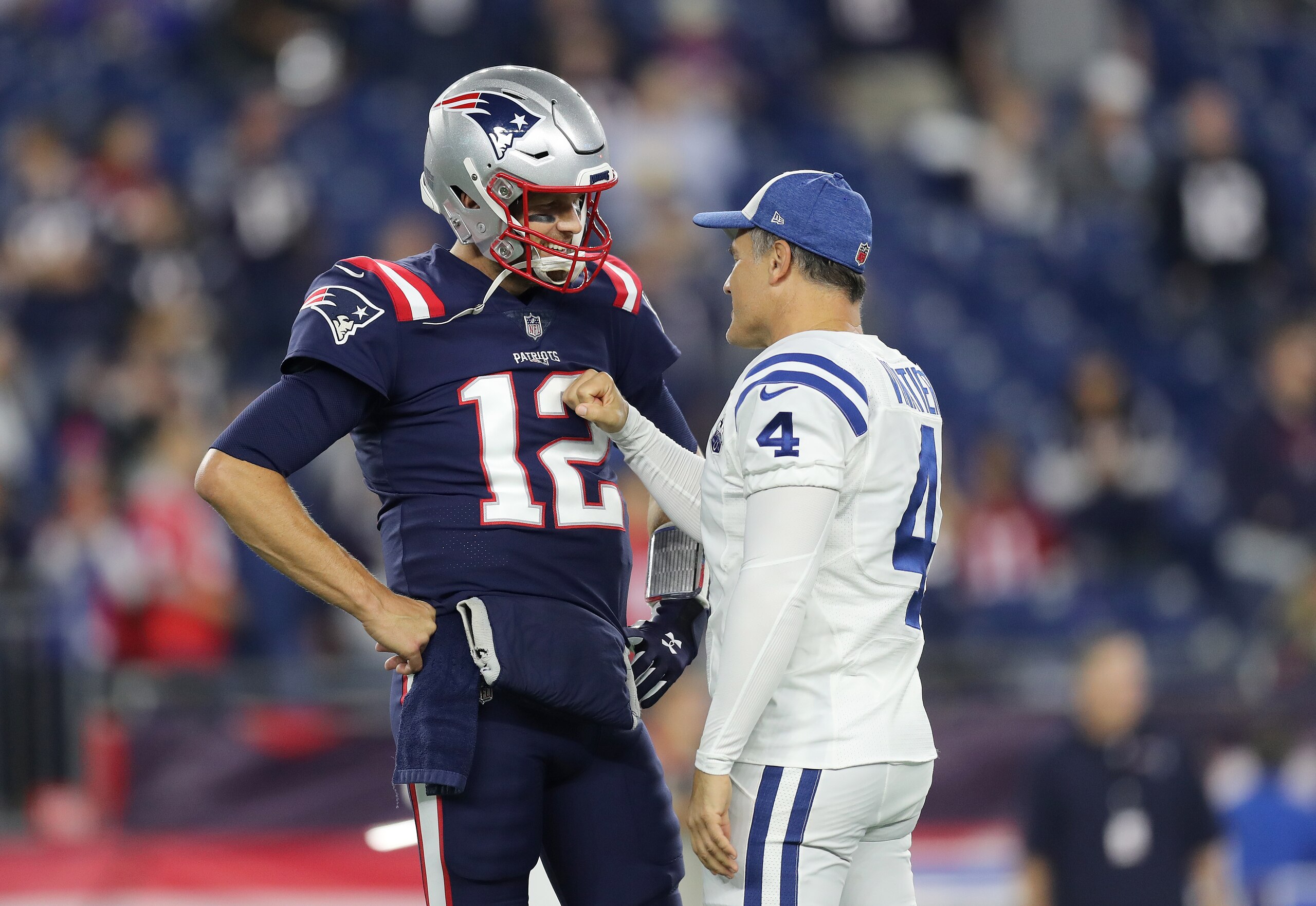 FOXBOROUGH, MA - OCTOBER 4: Indianapolis Colts and former New England Patriots kicker Adam Vinatieri gives a fist pump greeting to Patriots quarterback Tom Brady before the start of the game. The New England Patriots host the Indianapolis Colts in a regular season NFL football game at Gillette Stadium in Foxborough, MA on Oct. 4, 2018. (Photo by John Tlumacki/The Boston Globe via Getty Images) FOXBOROUGH, MA - OCTOBER 4: Indianapolis Colts and former New England Patriots kicker Adam Vinatieri gives a fist pump greeting to Patriots quarterback Tom Brady before the start of the game. The New England Patriots host the Indianapolis Colts in a regular season NFL football game at Gillette Stadium in Foxborough, MA on Oct. 4, 2018. (Photo by John Tlumacki/The Boston Globe via Getty Images)