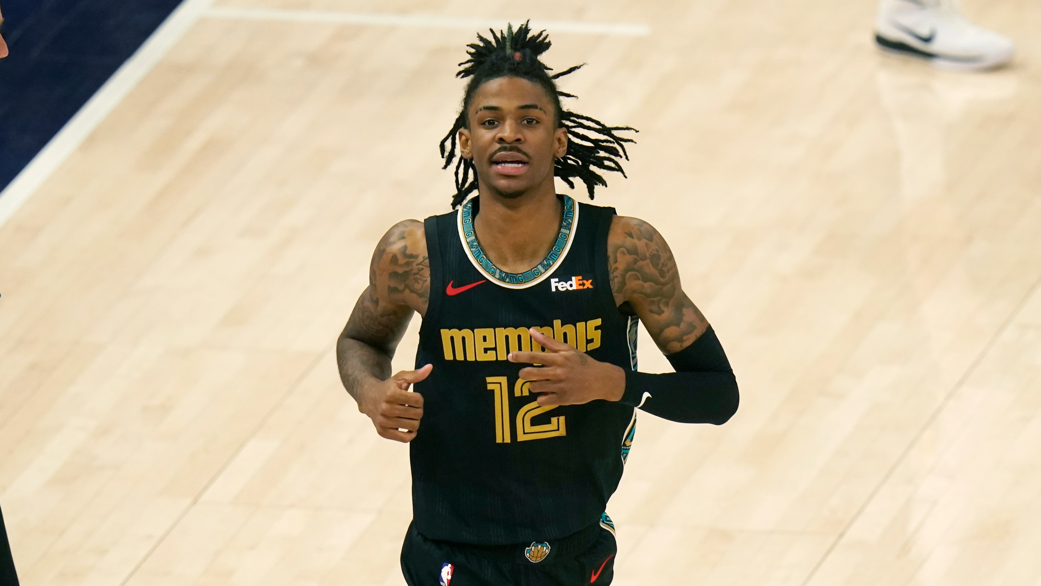 Memphis Grizzlies guard Ja Morant (12) runs up court during the second half of Game 1 of their NBA basketball first-round playoff series against the Utah Jazz Sunday, May 23, 2021, in Salt Lake City. (AP Photo/Rick Bowmer)