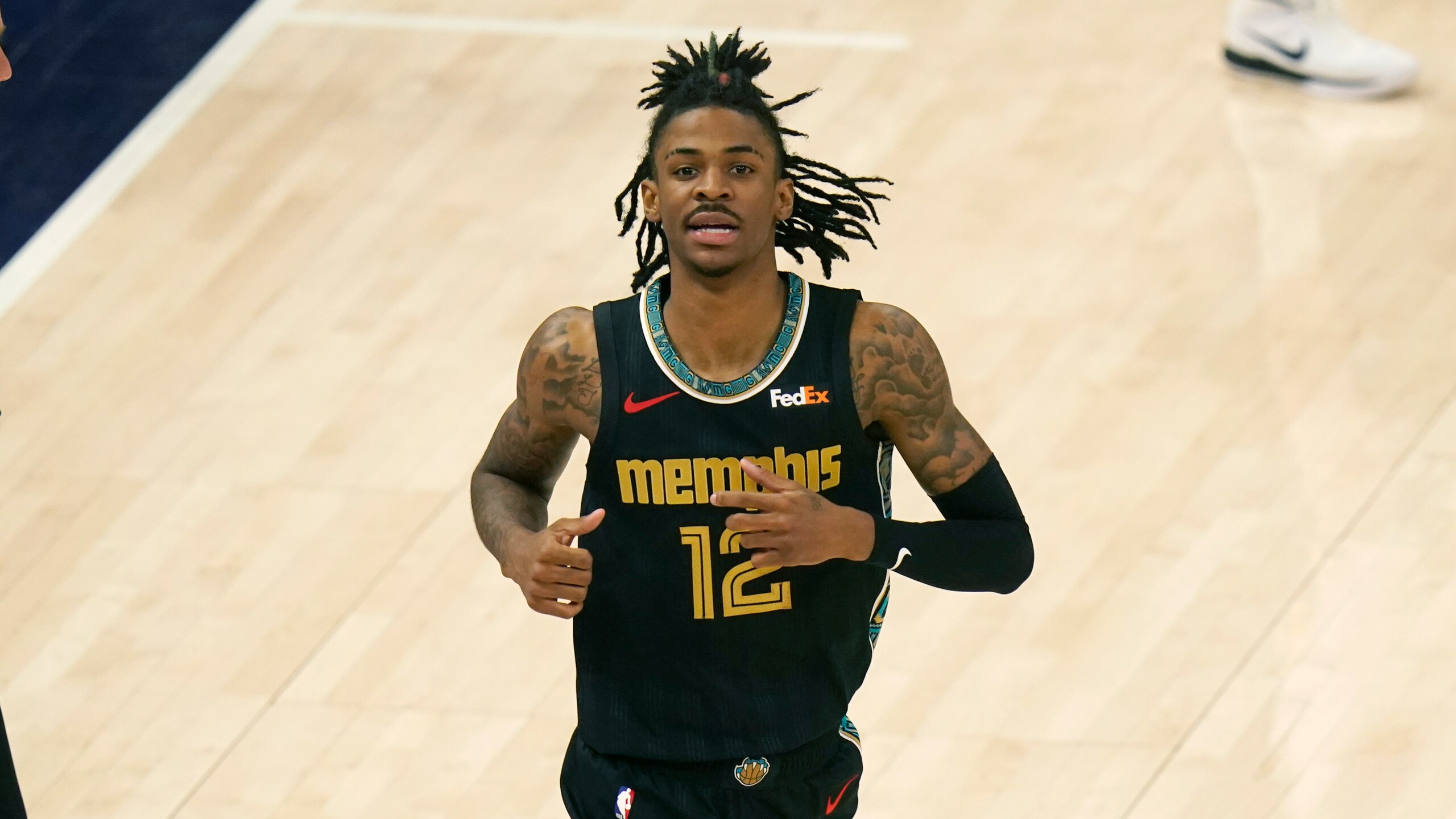 Memphis Grizzlies guard Ja Morant (12) runs up court during the second half of Game 1 of their NBA basketball first-round playoff series against the Utah Jazz Sunday, May 23, 2021, in Salt Lake City. (AP Photo/Rick Bowmer)