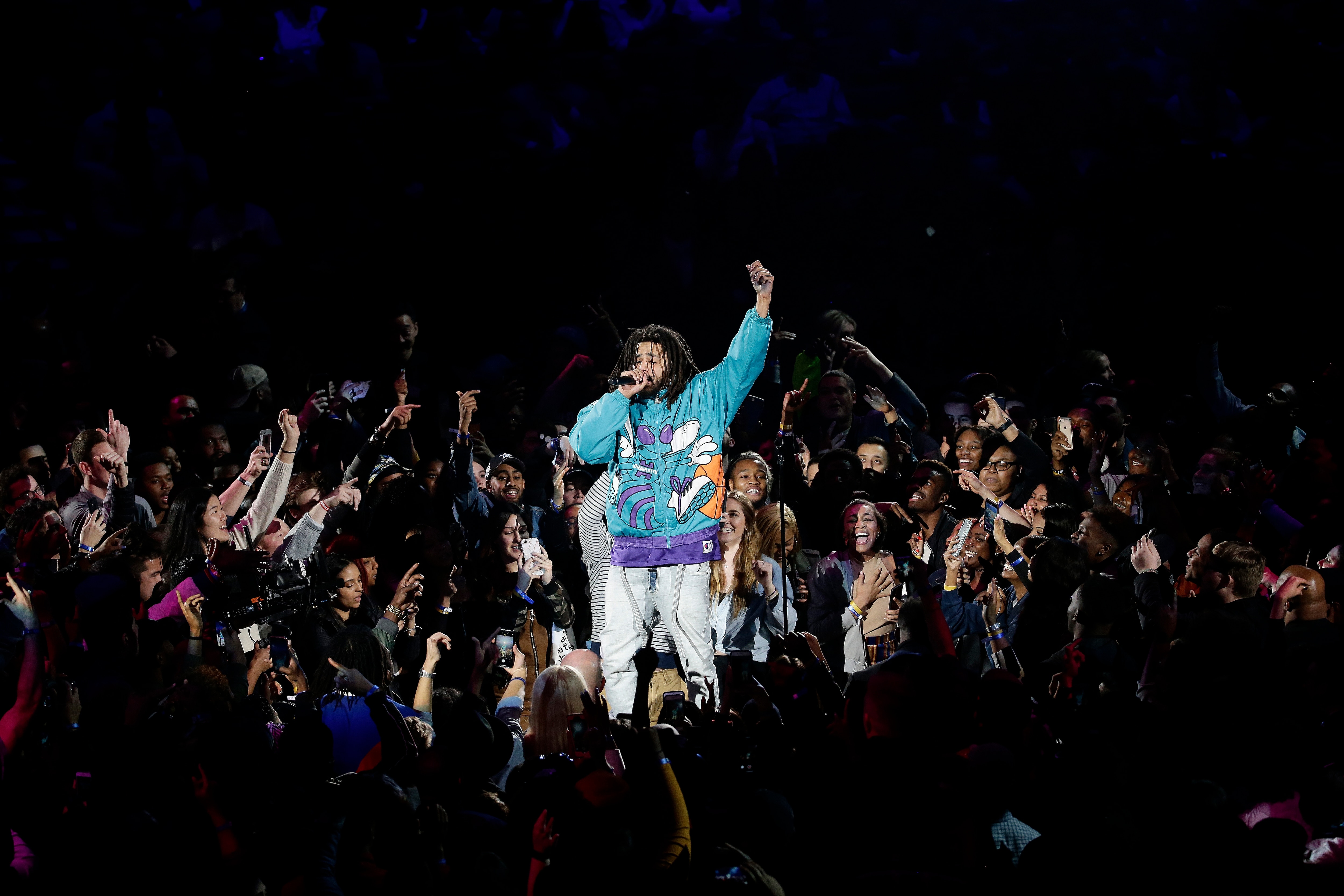 Rapper J. Cole performs at halftime during NBA All-Star basketball game, Sunday, Feb. 17, 2019, in Charlotte, N.C. (AP Photo/Gerry Broome)