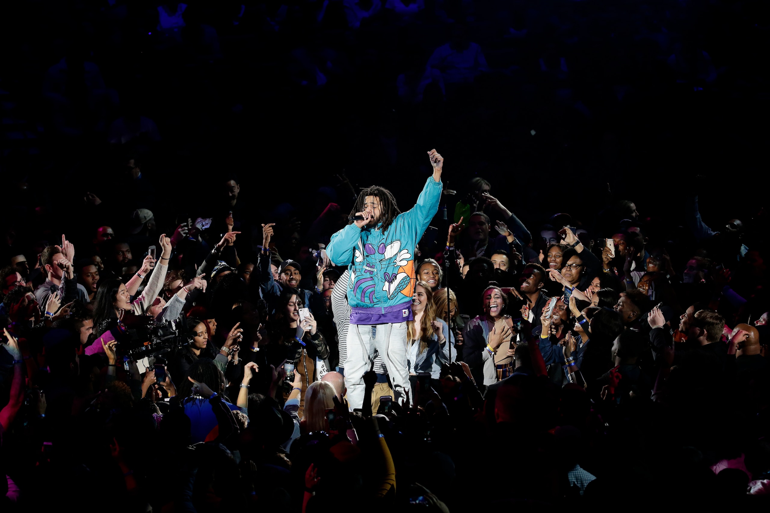 Rapper J. Cole performs at halftime during NBA All-Star basketball game, Sunday, Feb. 17, 2019, in Charlotte, N.C. (AP Photo/Gerry Broome)