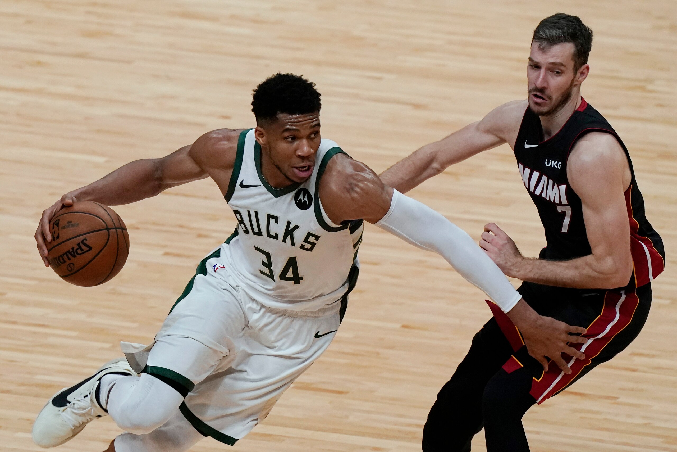 Milwaukee Bucks forward Giannis Antetokounmpo (34) goes around Miami Heat guard Goran Dragic (7) during the second half of Game 3 of an NBA basketball first-round playoff series Thursday, May 27, 2021, in Miami. The Bucks won 113-84. (AP Photo/Marta Lavandier)