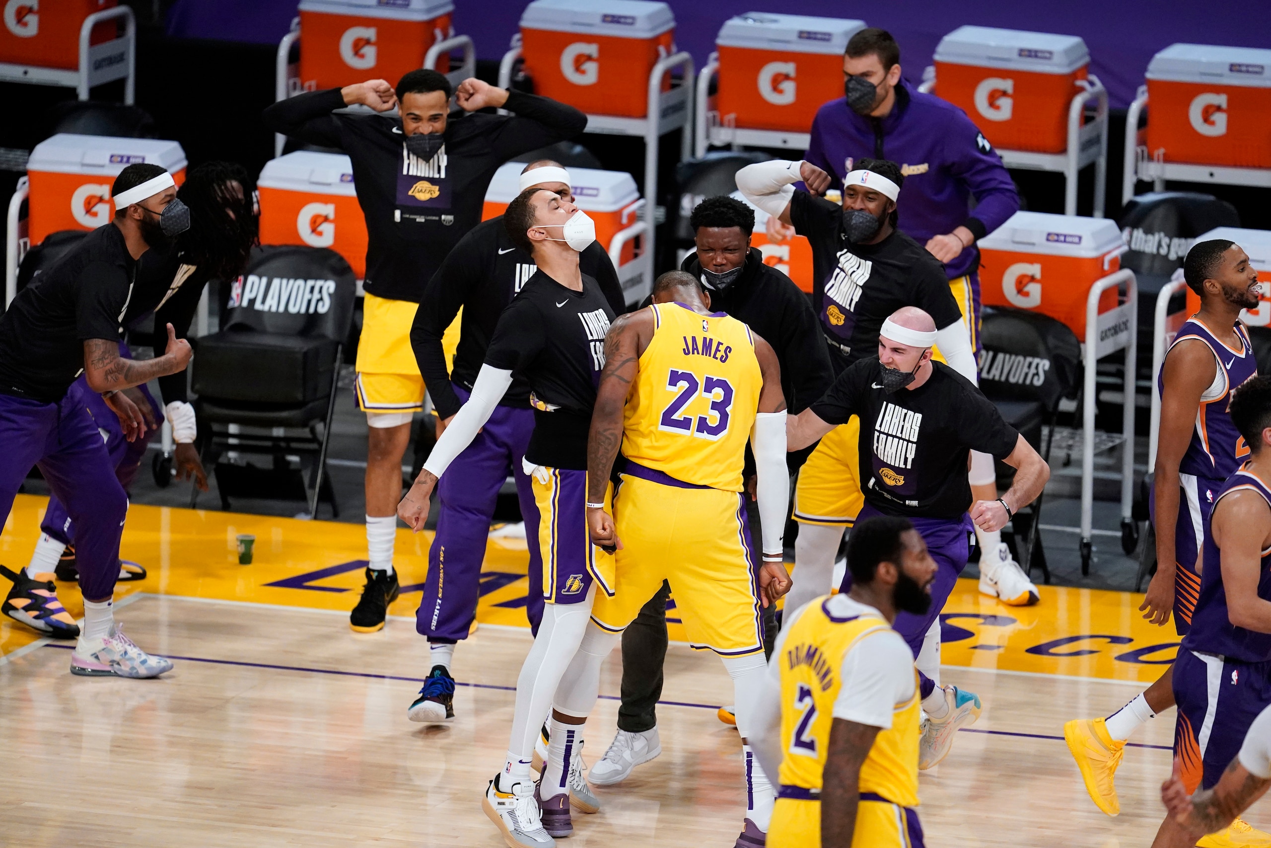 Los Angeles Lakers forward LeBron James (23) celebrates with teammates after scoring against the Phoenix Suns during the second half in Game 3 of an NBA basketball first-round playoff series Thursday, May 27, 2021, in Los Angeles. (AP Photo/Marcio Jose Sanchez)