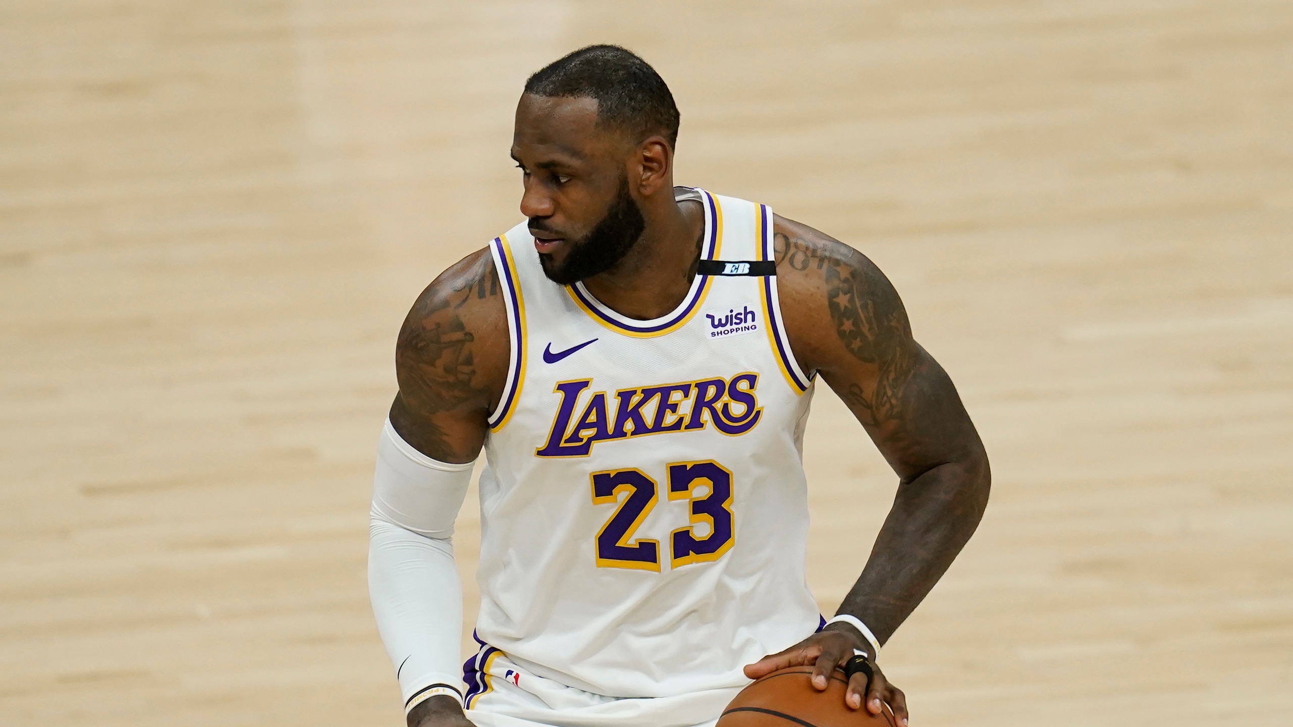 Los Angeles Lakers forward LeBron James dribbles the ball against the Phoenix Suns during the first half of Game 1 of their NBA basketball first-round playoff series Sunday, May 23, 2021, in Phoenix. (AP Photo/Ross D. Franklin)