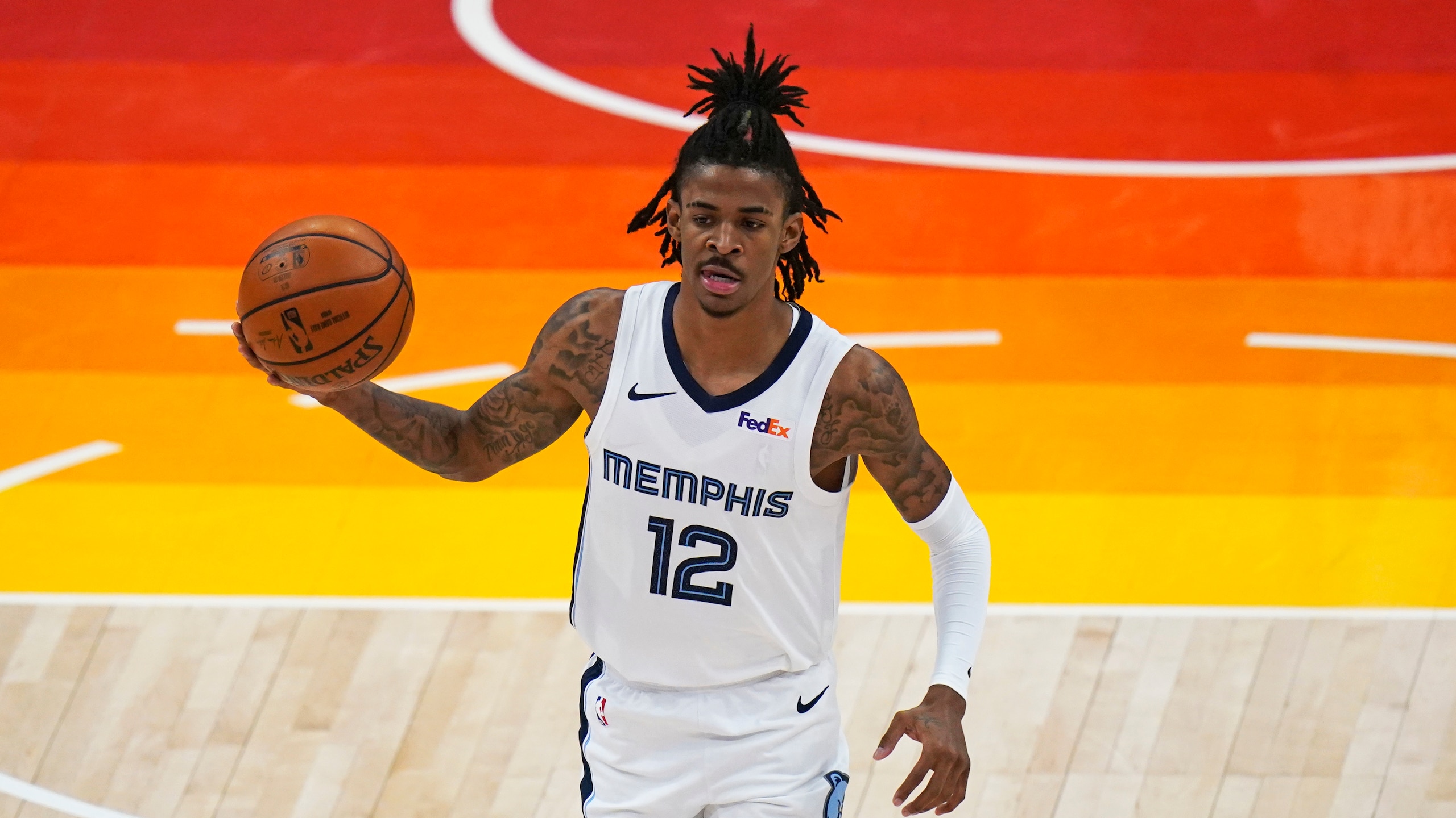Memphis Grizzlies guard Ja Morant (12) brings the ball up court during the first half of Game 2 of their NBA basketball first-round playoff series against the Utah Jazz Wednesday, May 26, 2021, in Salt Lake City. (AP Photo/Rick Bowmer)