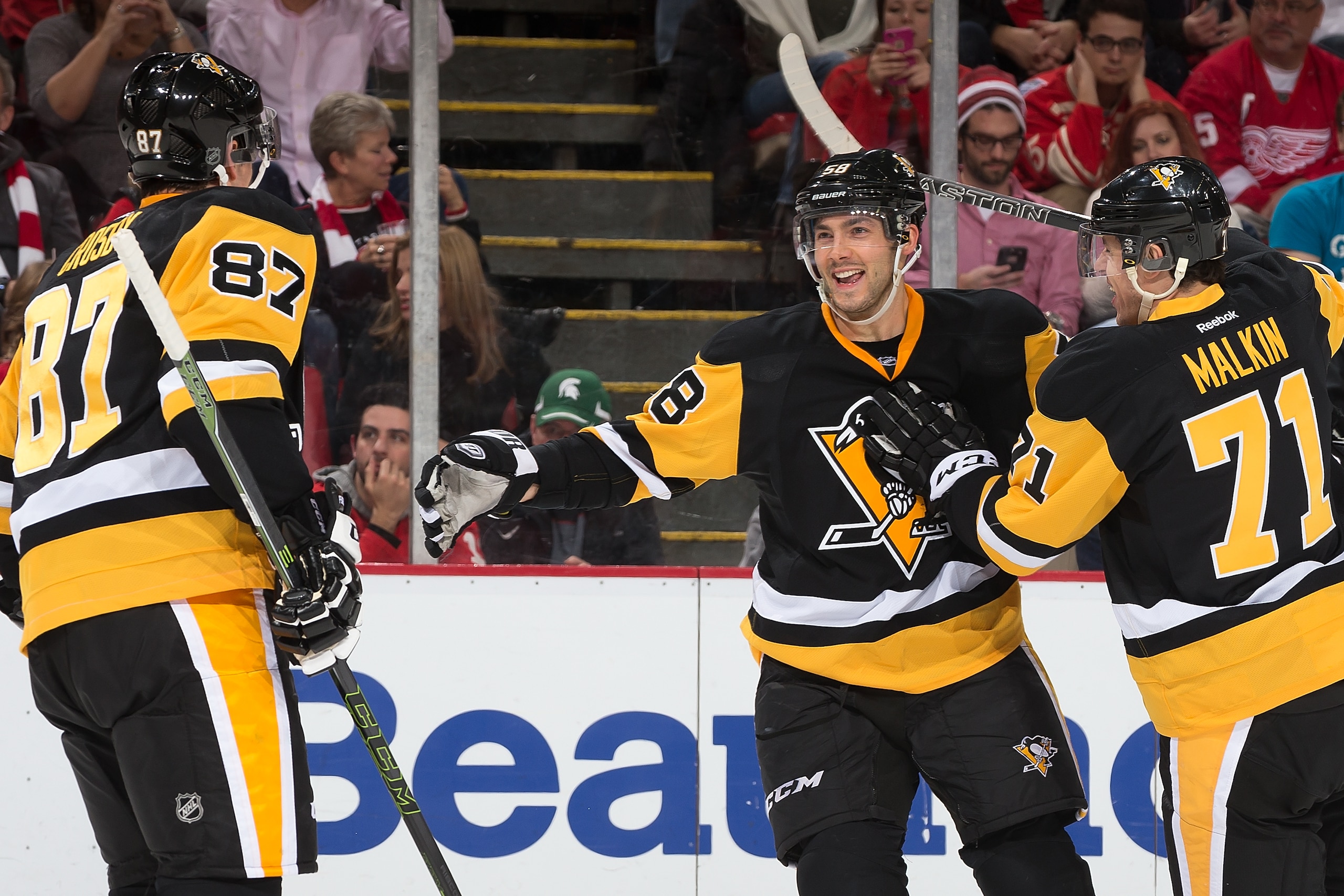 DETROIT, MI - DECEMBER 31: Kris Letang #58 of the Pittsburgh Penguins celebrates his power play goal with teammates Sidney Crosby #87 and Evgeni Malkin #71 in the second period of an NHL game against the Detroit Red Wings at Joe Louis Arena on December 31, 2015 in Detroit, Michigan. The Penguins defeated the Wings 5-2. (Photo by Dave Reginek/NHLI via Getty Images)
