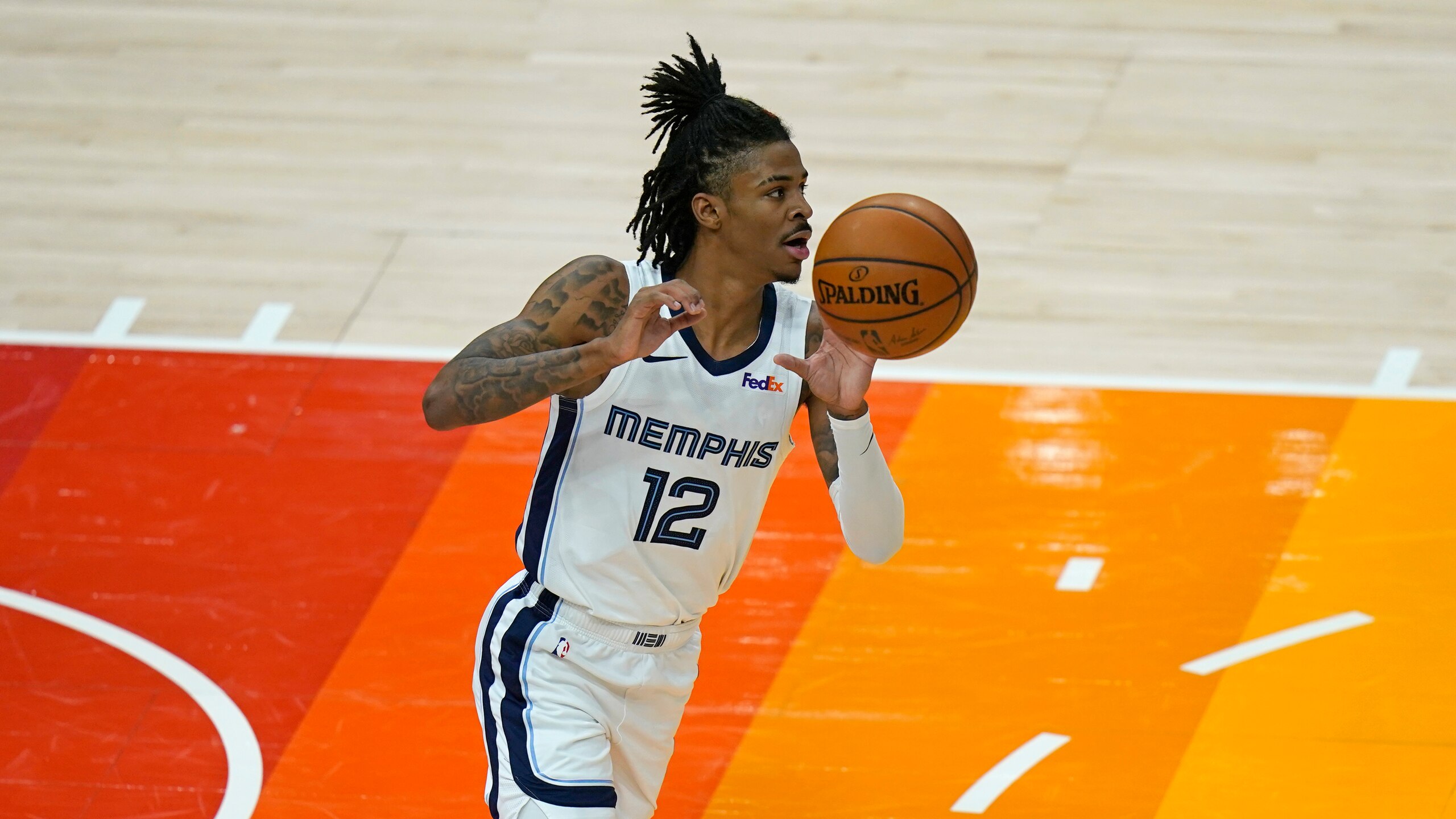 Memphis Grizzlies guard Ja Morant (12) brings the ball up court during the second half of Game 2 of their NBA basketball first-round playoff series against the Utah Jazz Wednesday, May 26, 2021, in Salt Lake City. (AP Photo/Rick Bowmer)