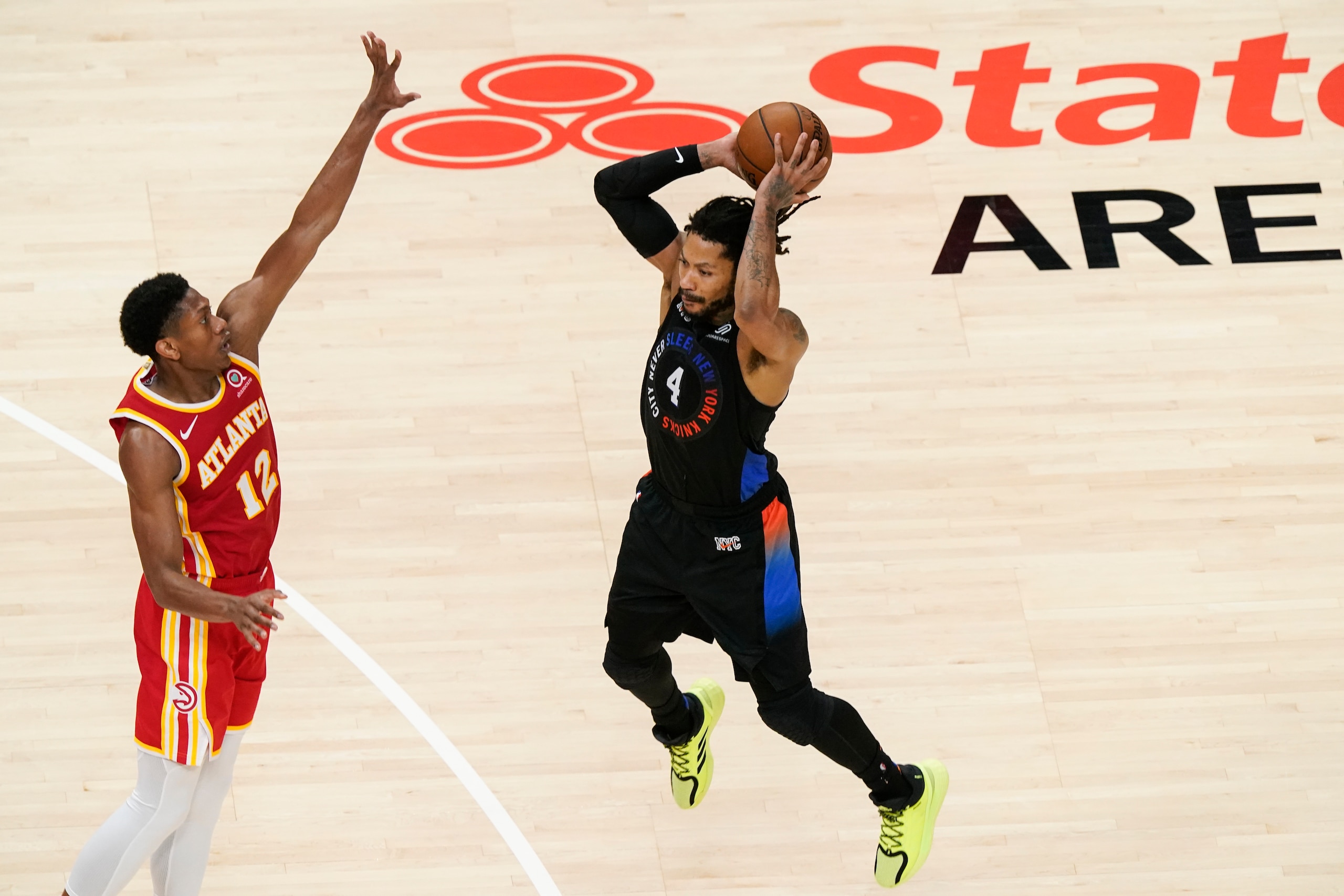 Atlanta Hawks forward De'Andre Hunter (12) and New York Knicks guard Derrick Rose (4) during the second half in Game 3 of an NBA basketball first-round playoff series Friday, May 28, 2021, in Atlanta. (AP Photo/Brynn Anderson)