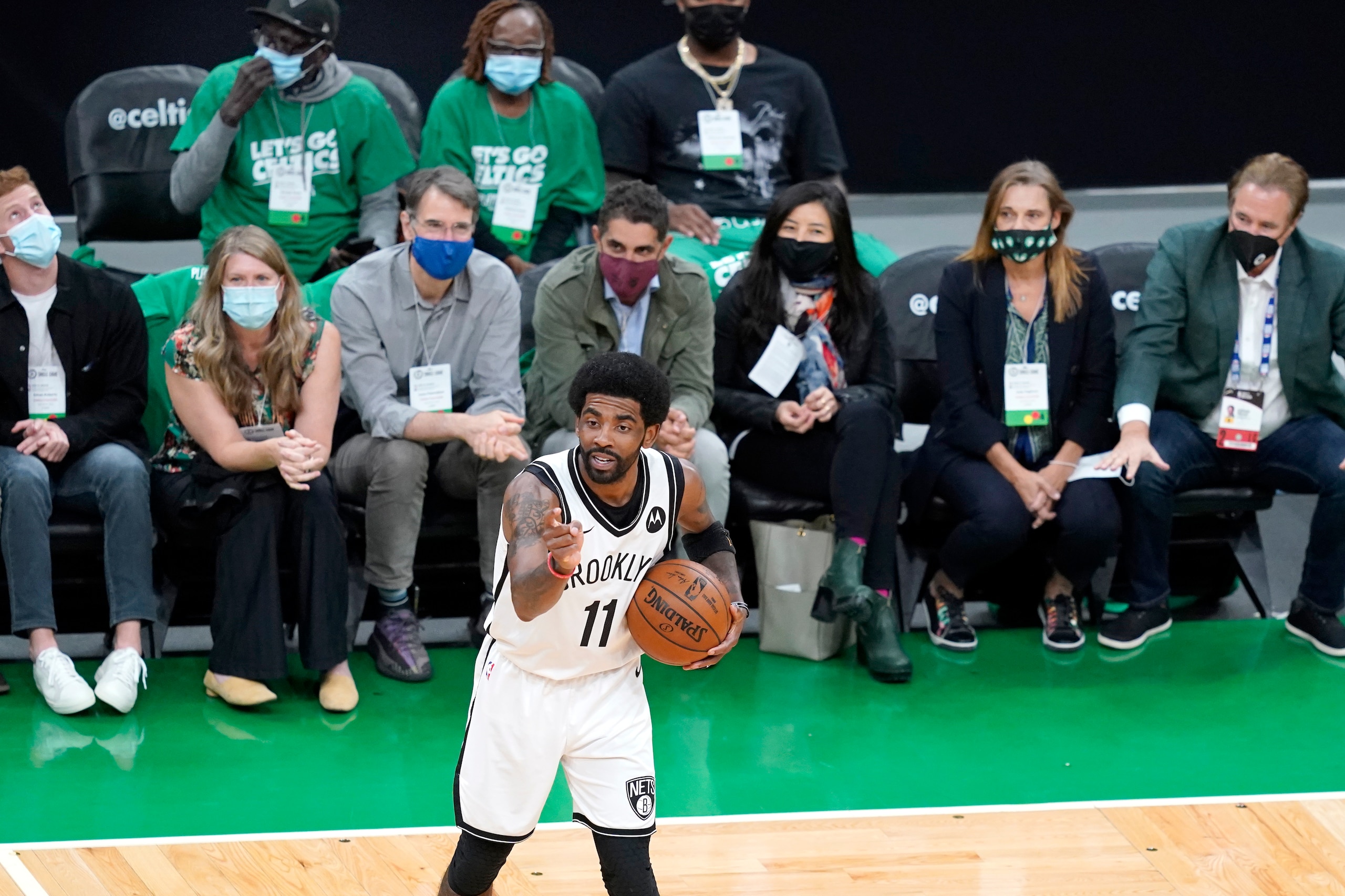 Fans watch as Brooklyn Nets guard Kyrie Irving handles the ball in the second quarter of Game 3 against the Boston Celtics during an NBA basketball first-round playoff series, Friday, May 28, 2021, in Boston. Irving, an ex-Celtic, was repeatedly booed by the TD Garden fans. (AP Photo/Elise Amendola)