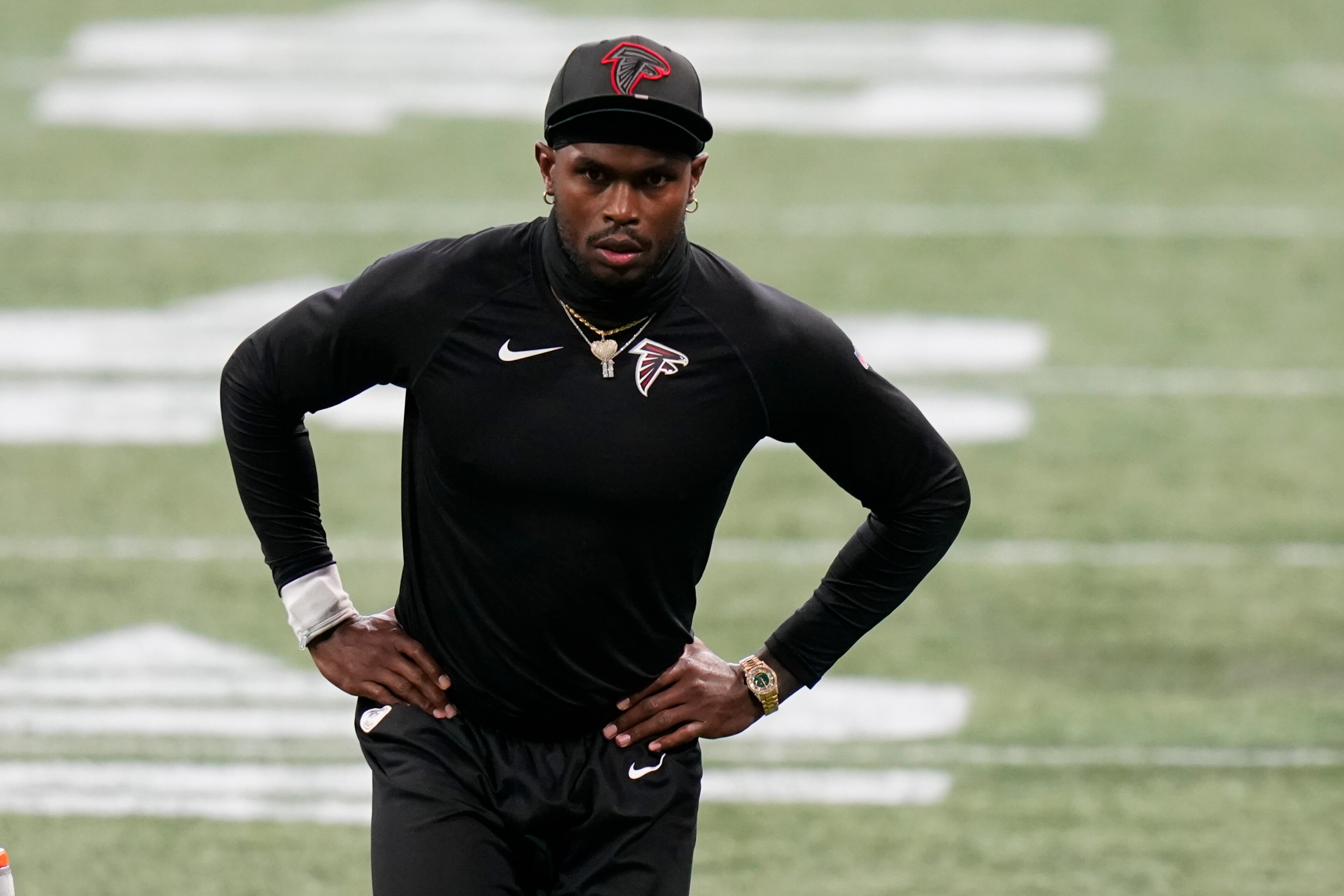 Atlanta Falcons wide receiver Julio Jones stretches before the first half of an NFL football game between the Atlanta Falcons and the Carolina Panthers, Sunday, Oct. 11, 2020, in Atlanta. Jones is not playing due to injury. (AP Photo/Brynn Anderson)