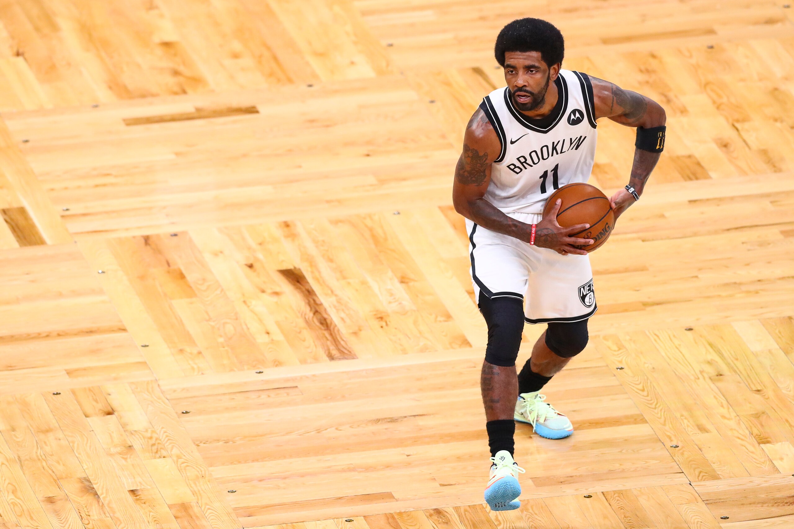BOSTON, MA - MAY 28:  Kyrie Irving #11 of the Brooklyn Nets handless the ball during Game Three of the Eastern Conference first round series against the Boston Celtics at TD Garden on May 28, 2021 in Boston, Massachusetts. NOTE TO USER: User expressly acknowledges and agrees that, by downloading and or using this photograph, User is consenting to the terms and conditions of the Getty Images License Agreement. (Photo by Adam Glanzman/Getty Images)